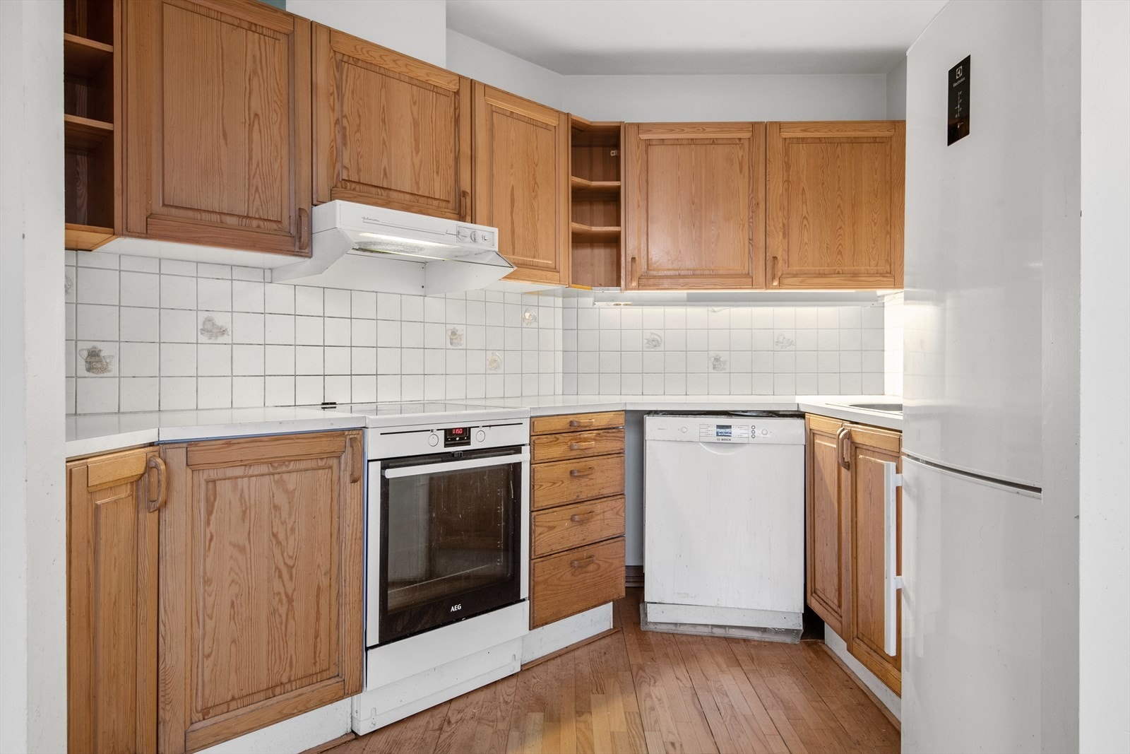 Kjøkkenet har profilerte fronter og er utstyrt med komfyr, ventilator med kanal til yttervegg, oppvaskmaskin og kjøl/fryseskap. Disse medfølger salget. Galleribilde