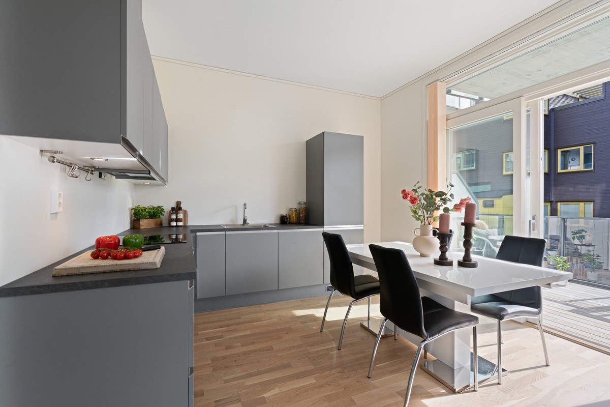 Romslig kjøkken med god plass til et spisebord. Kjøkkeninnredningen har mye skap-/og benkeplass Galleribilde