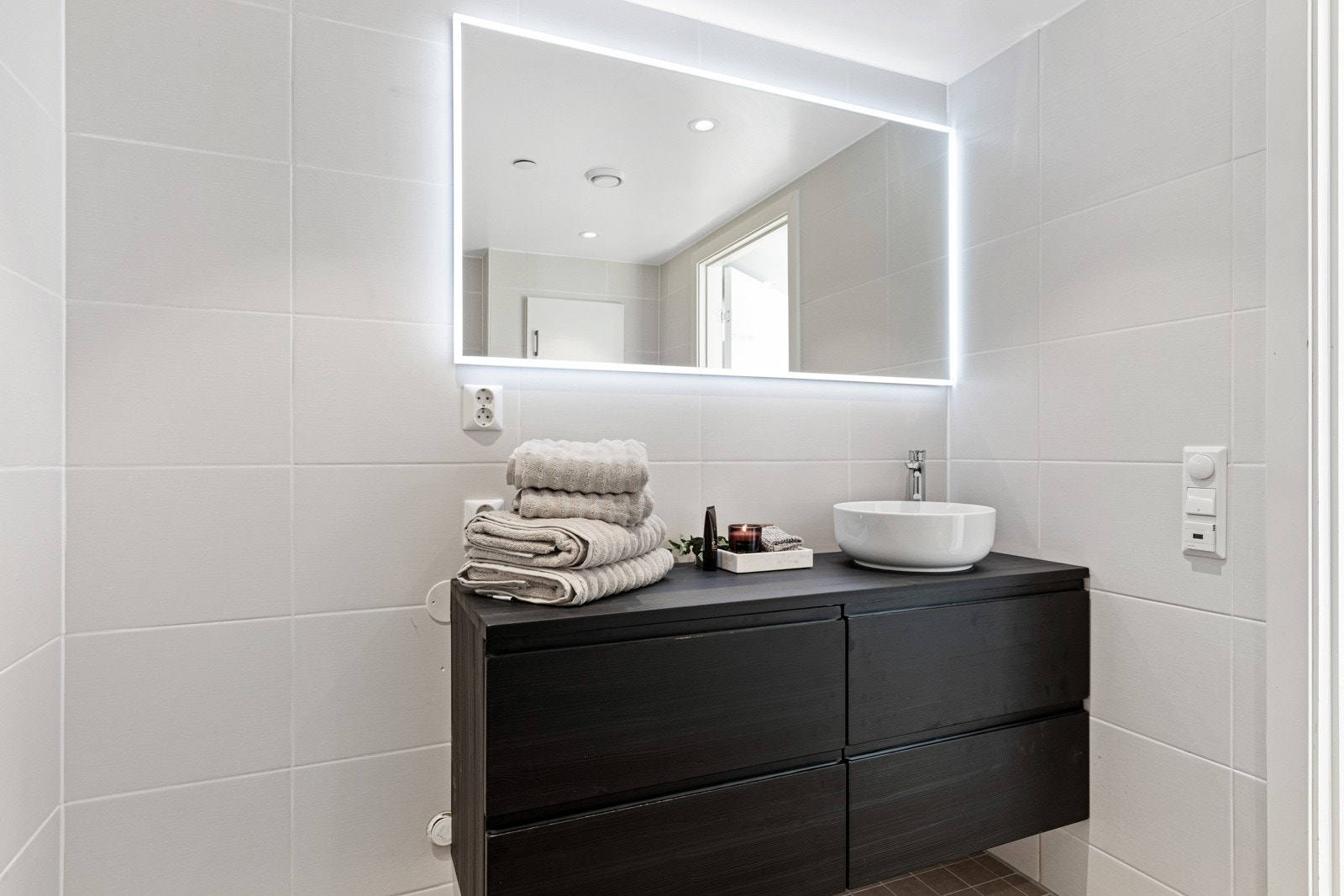 Det ca. 5 kvm store badet er stilrent innredet med delikate fliser på både vegger og gulv. Galleribilde