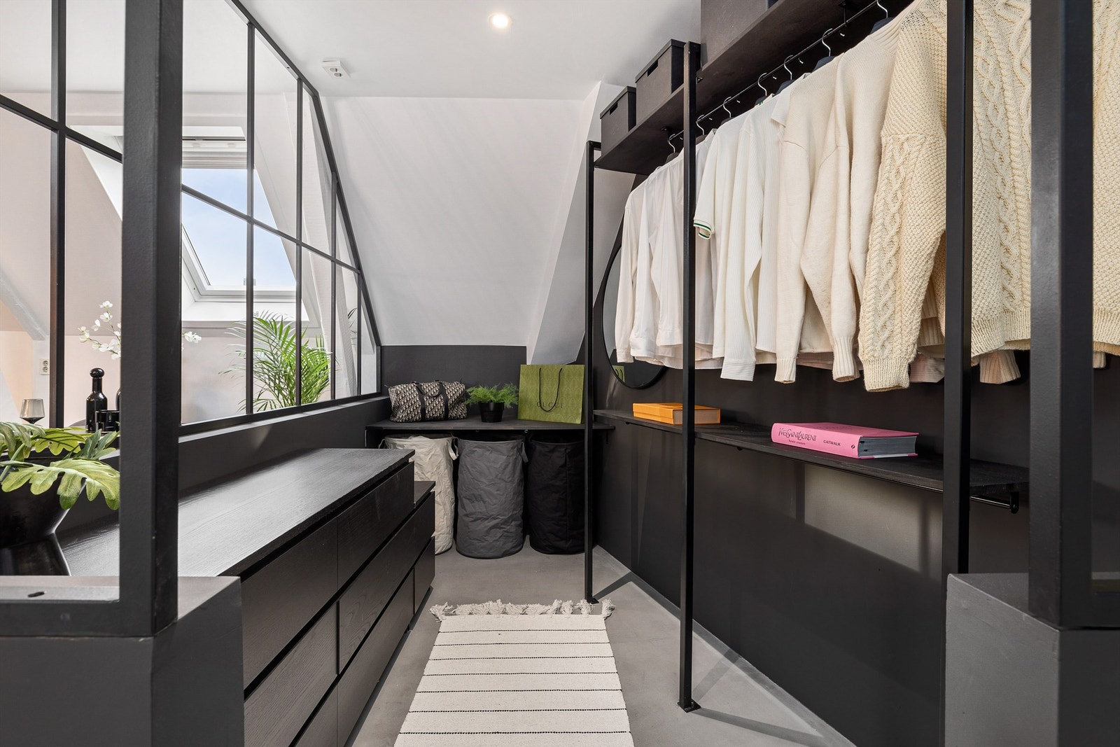 Fra entréen har du direkte tilgang til stort garderoberom med spesiallaget industrivegg med kleshengere og kommoder Galleribilde