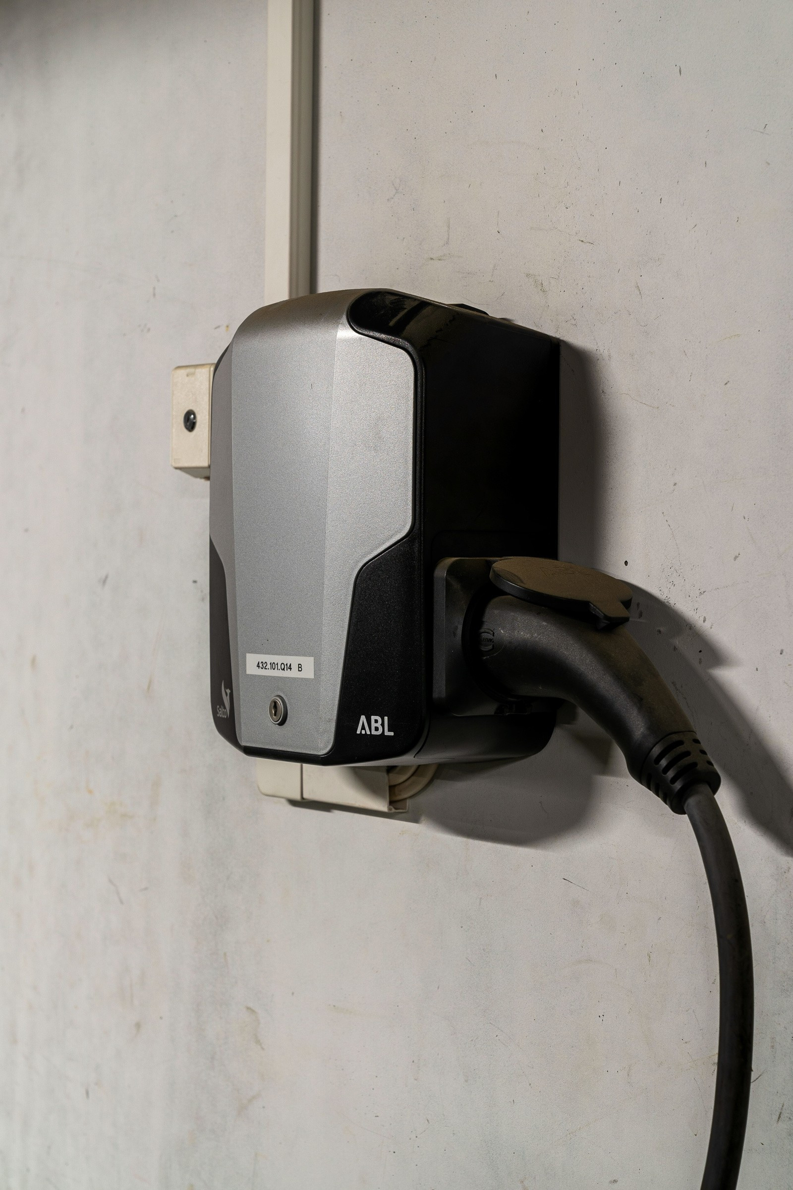 Montert elbillader ved parkeringsplass.