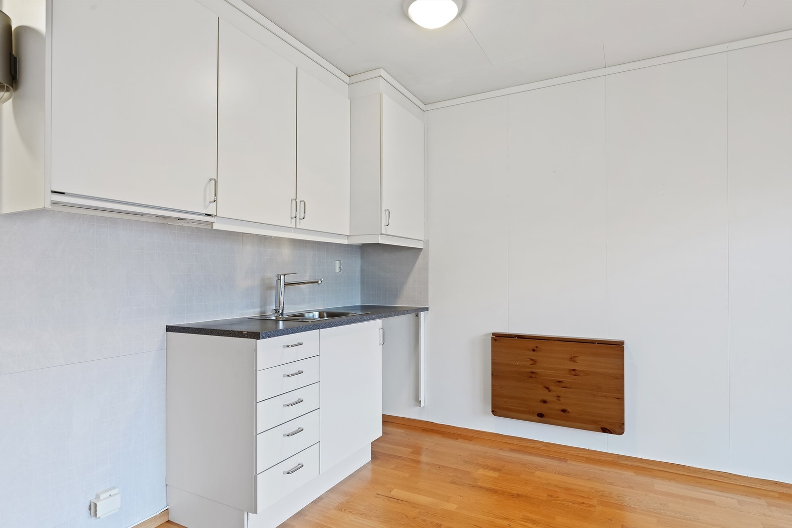 Kjøkkenet. Praktisk veggmontert spisebord som kan felles ned. Galleribilde