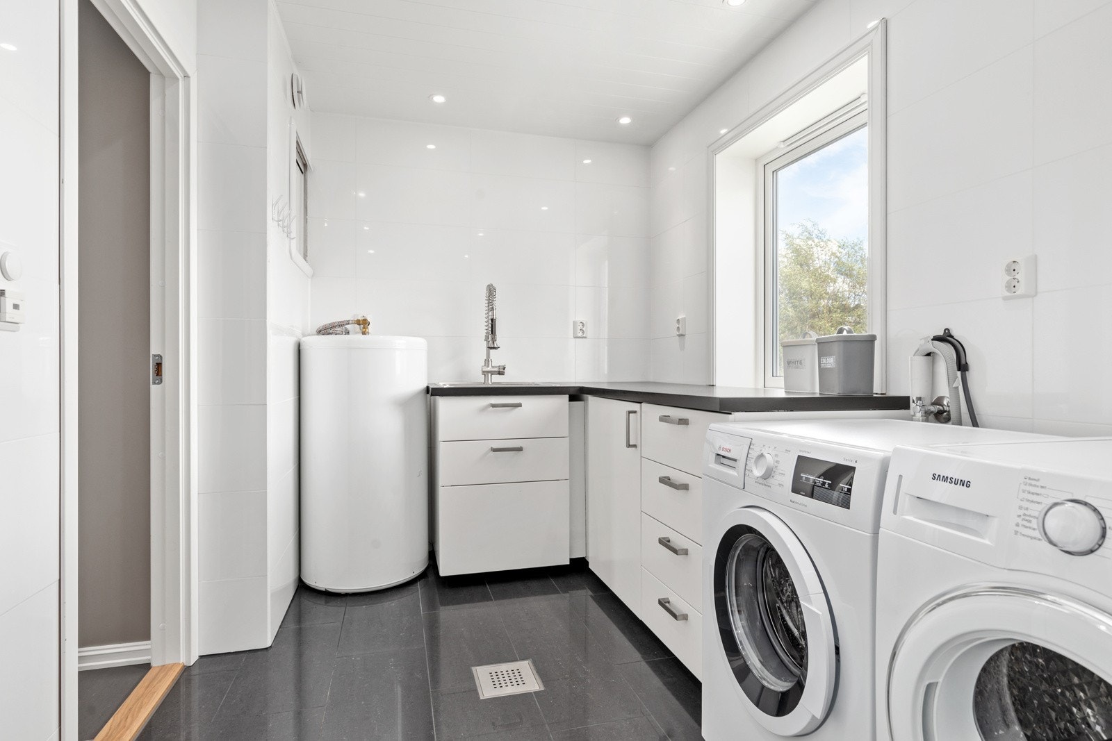 Vaskerommet er på hele 8 kvm og er utstyrt med vask, mye skap- og benkeplass og opplegg for vaskemaskin. Her er det også behagelig varme i gulv. Galleribilde