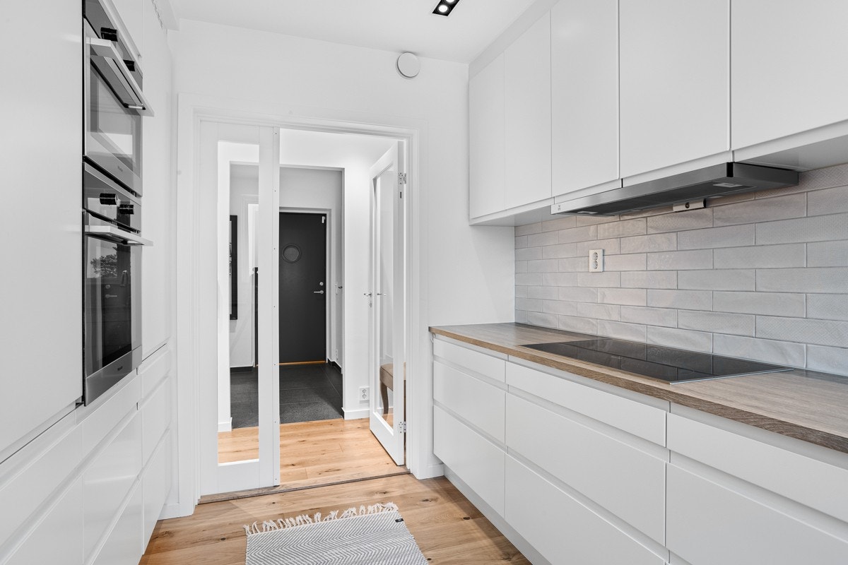 Det velinnredede kjøkkenet har innredning fra Sigdal med takoppforede skap og hvite grepsfrie fronter. Galleribilde