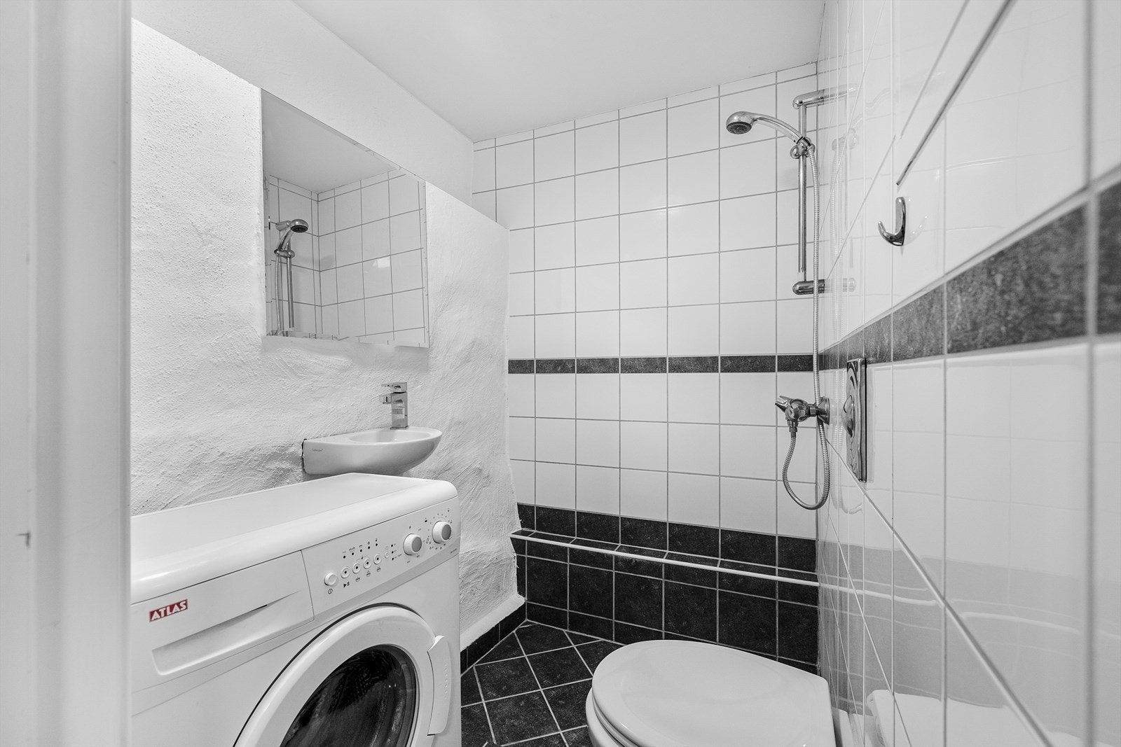 Pent flislagt baderom med elektriske varmekabler i gulv og vaskemaskin som medfølger Galleribilde