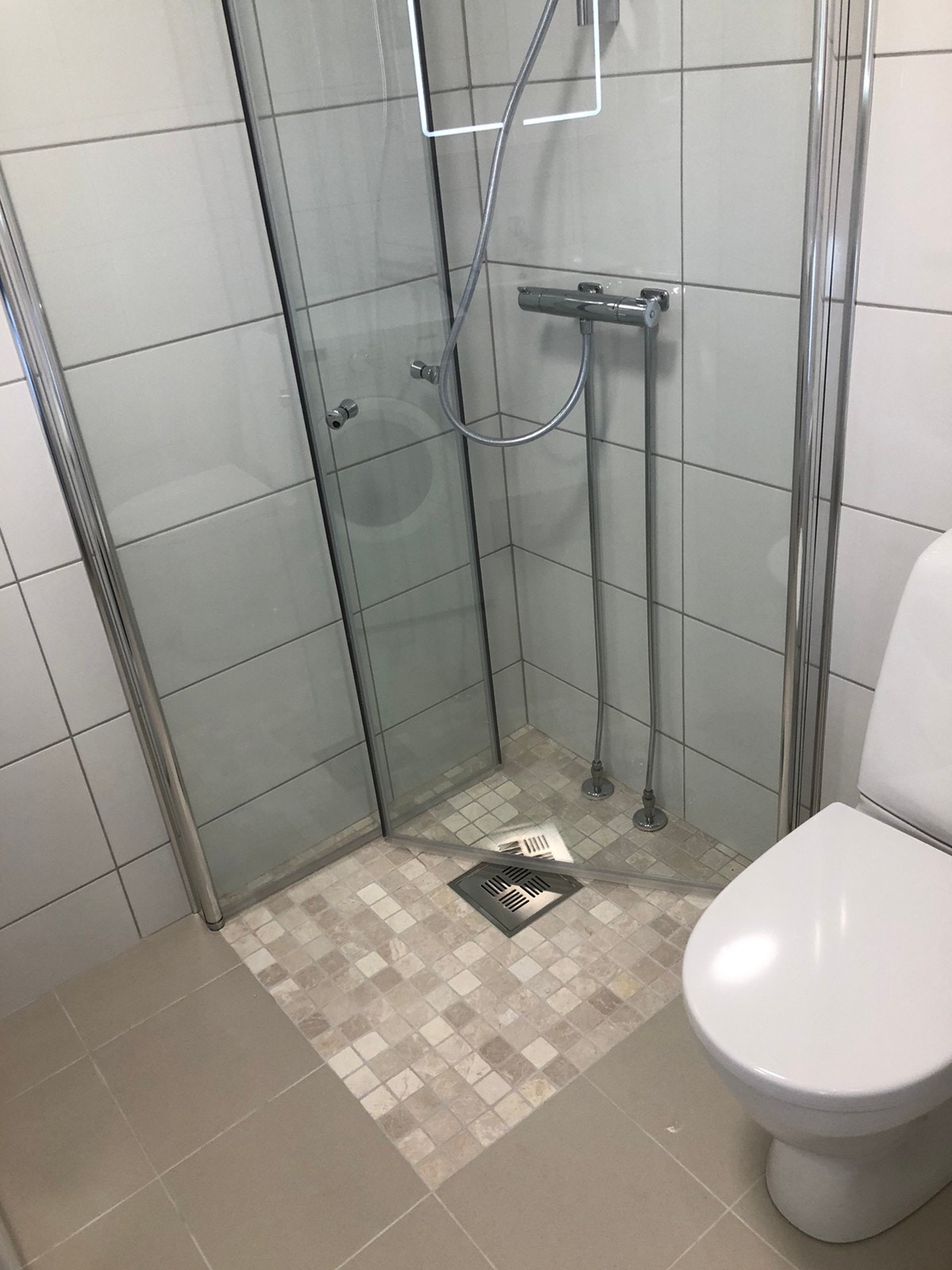 Nyoppusset (2021), lekkert bad med dusj, servant, speilskap med lys og stikkontakt, toalett og vaskemaskin med tørketrommel. Galleribilde