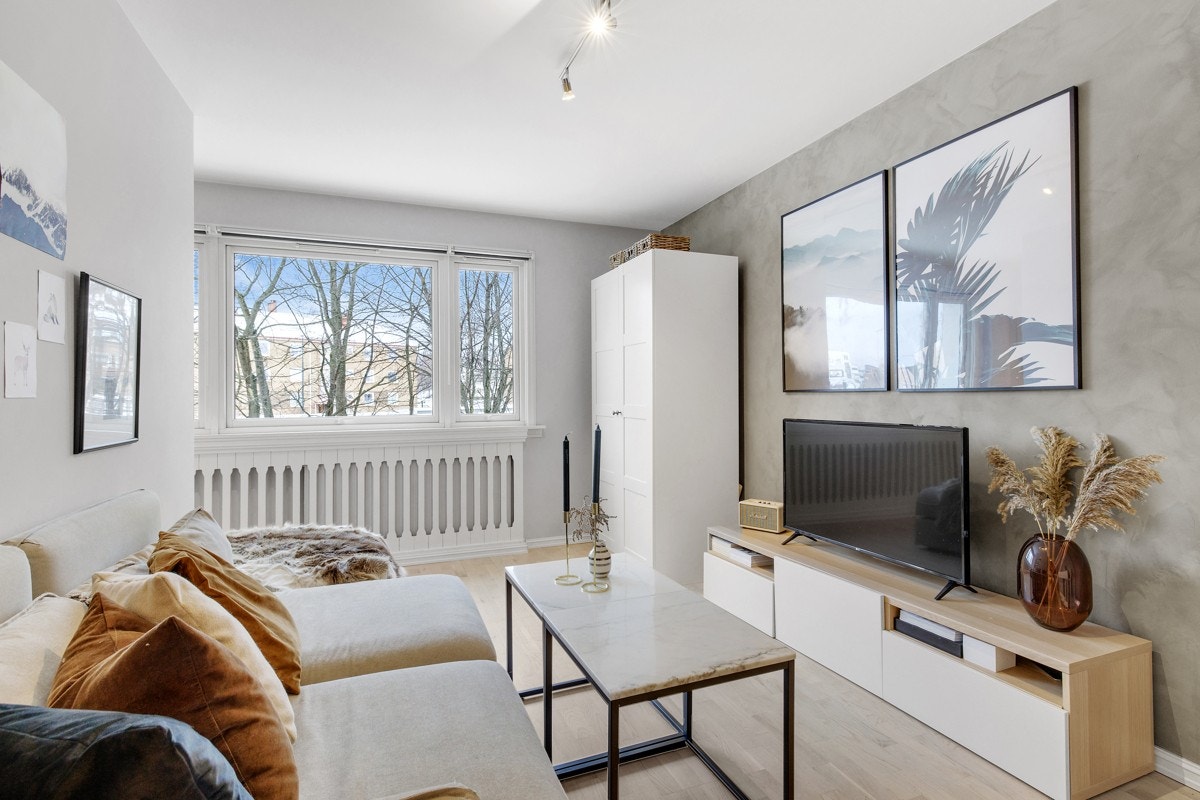 Stuen har store vindusflater som slipper inn godt med naturlig lys Galleribilde