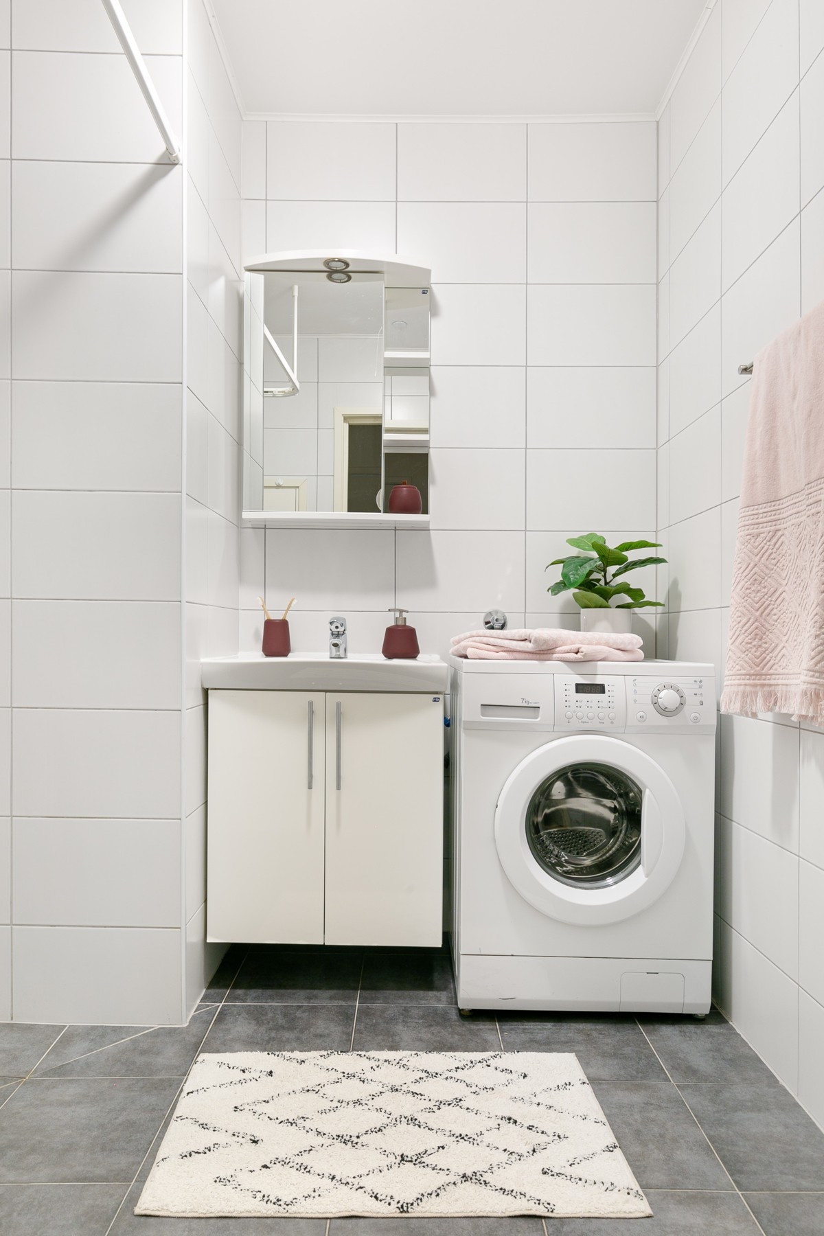 Bilde er tatt fra tilsvarende leilighet/Badet er utstyrt med dusjkabinett, servant m/innredning, vegghengt toalett og opplegg til vaskemaskin