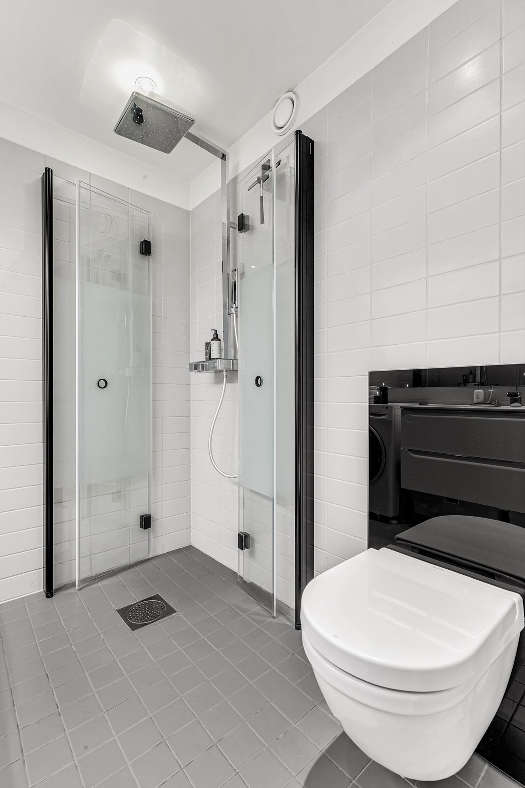 Badet er utstyrt med dusjnisje med innfellbare glassvegger, vegghengt wc, romslig servantinnredning med skuffer, samt opplegg og plass til vaskemaskin. Galleribilde