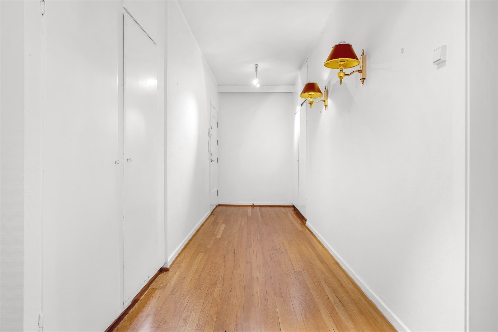 Romslig hall/entré med plassbygde garderobeskap på begge sider Galleribilde