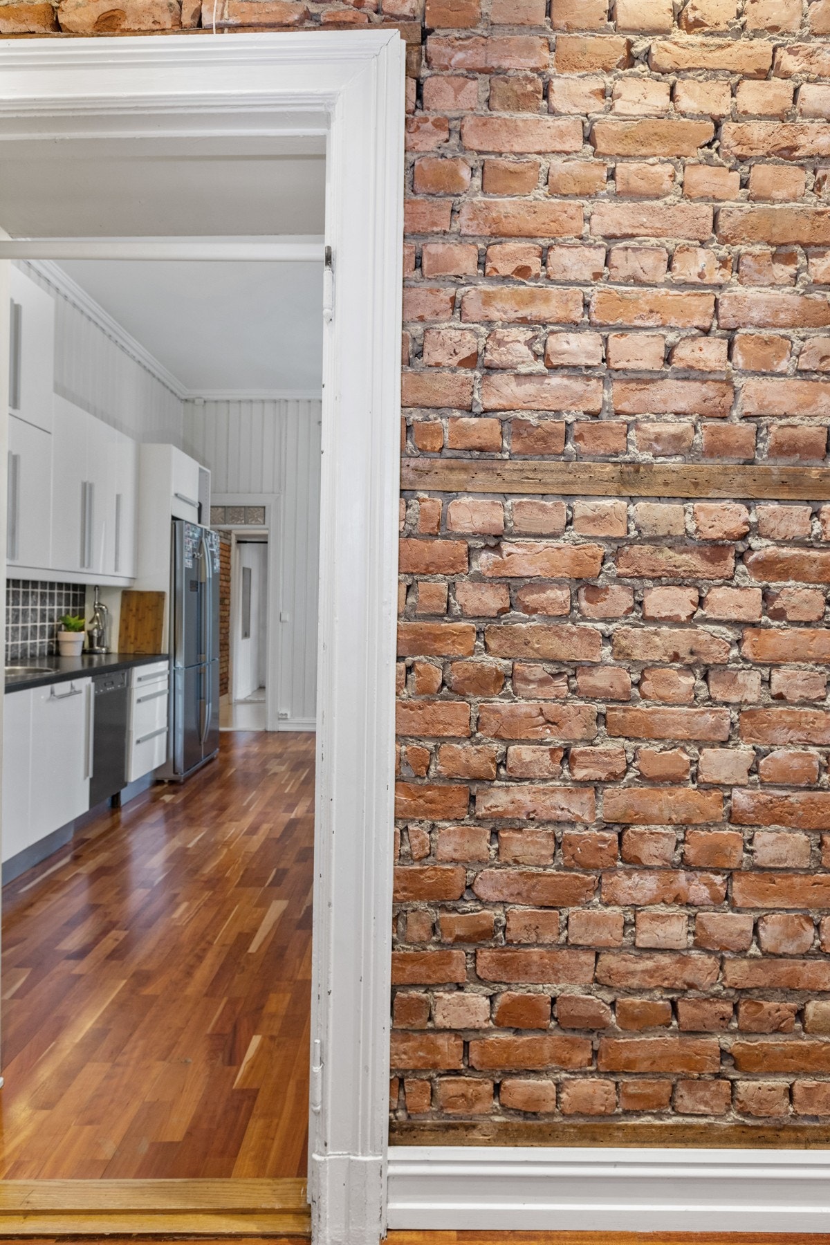 De lysmalte veggene i kombinasjon med den eksponerte, originale teglsteinen, gir et lunt og godt førsteinntrykk. Galleribilde