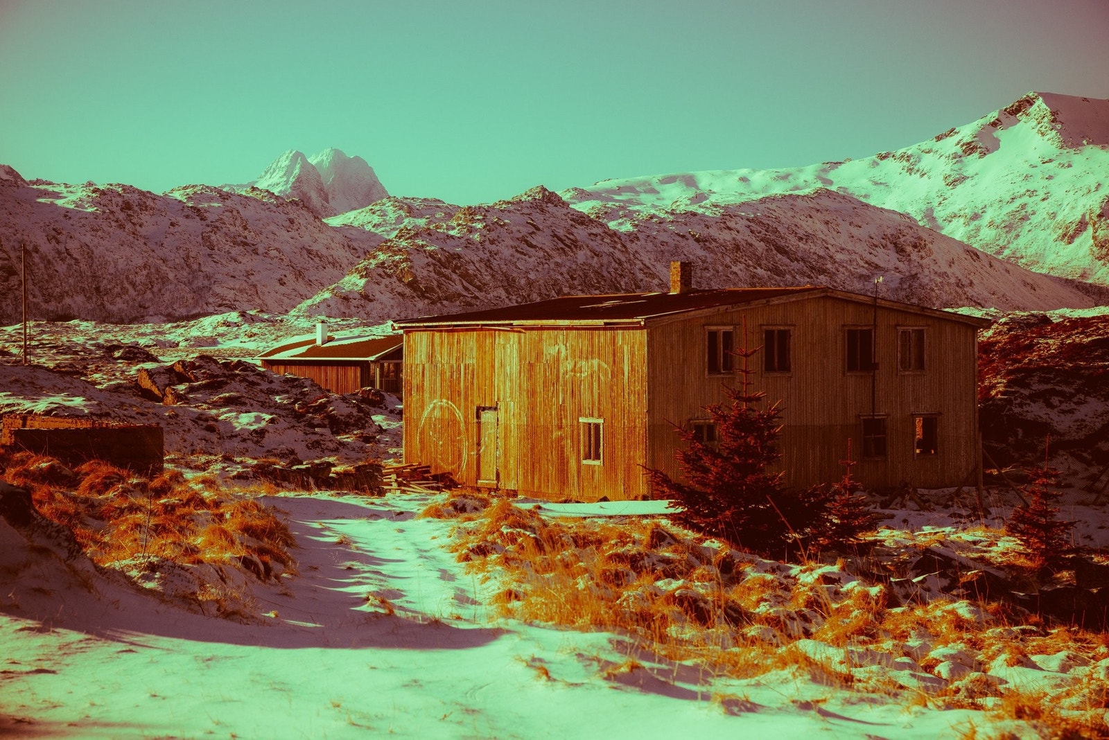 Stor mannskapsbrakke hvor fiskerne tidligere bodde og arbeidet. Himmeltind i bakgrunnen. Foto: Steffen Larsen. Galleribilde