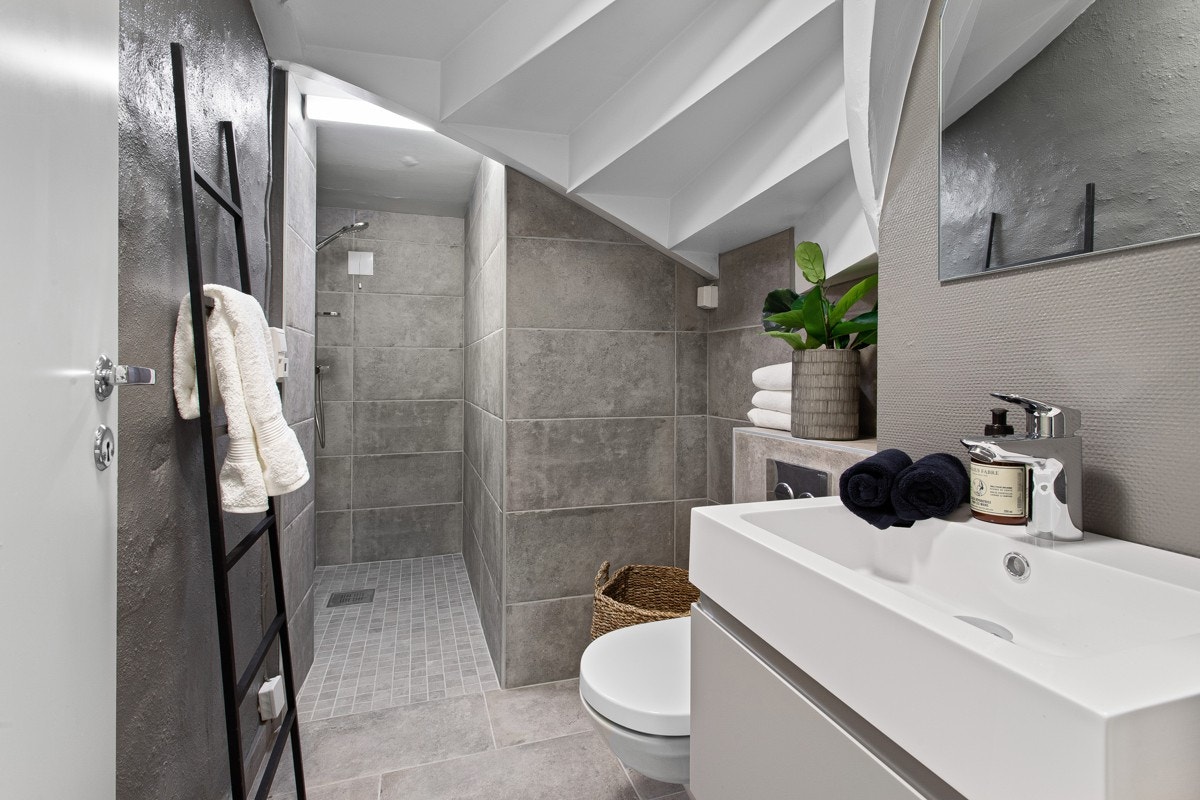 Leiligheten har et lekkert bad fra 2020 med varmekabler, servantskap med heldekkende servant, vegghengt wc, opplegg for vaskemaskin og lekker dusj. Galleribilde