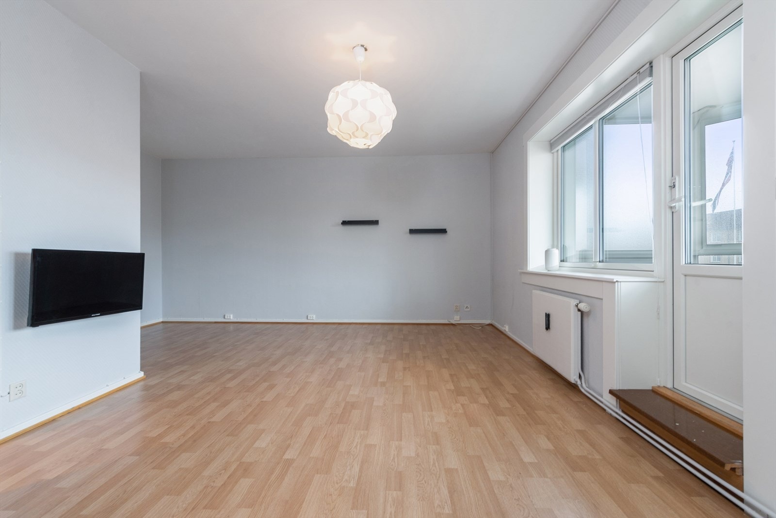 Rommet har plass til sofagruppe med tilhørende bord og veggmontert TV. Galleribilde
