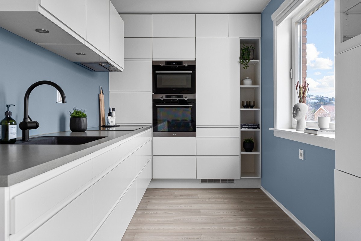 Lekkert og moderne HTH kjøkken fra 2017 som har innredning med hvite og slette fronter, samt benkeplate av laminat. Galleribilde