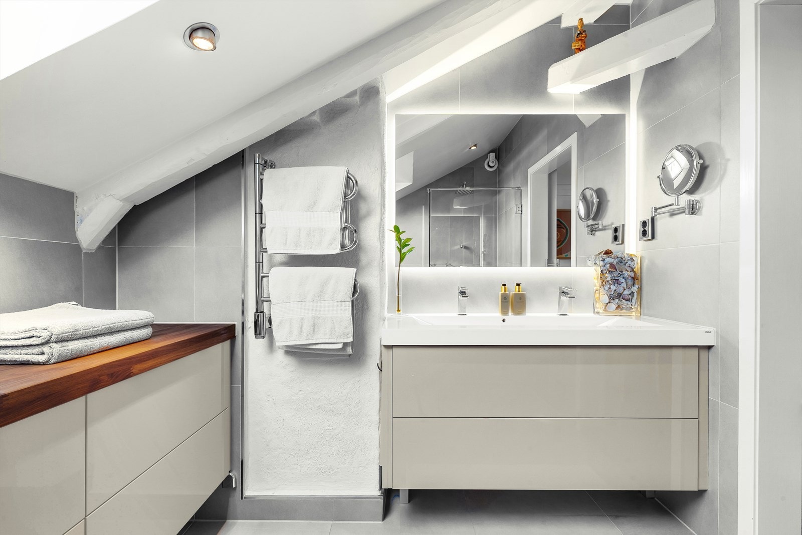 Delikat bad med dobbelservant, stort speil med bakgrunnsbelysning, elektrisk håndkletørker og rikelig med skapplass Galleribilde