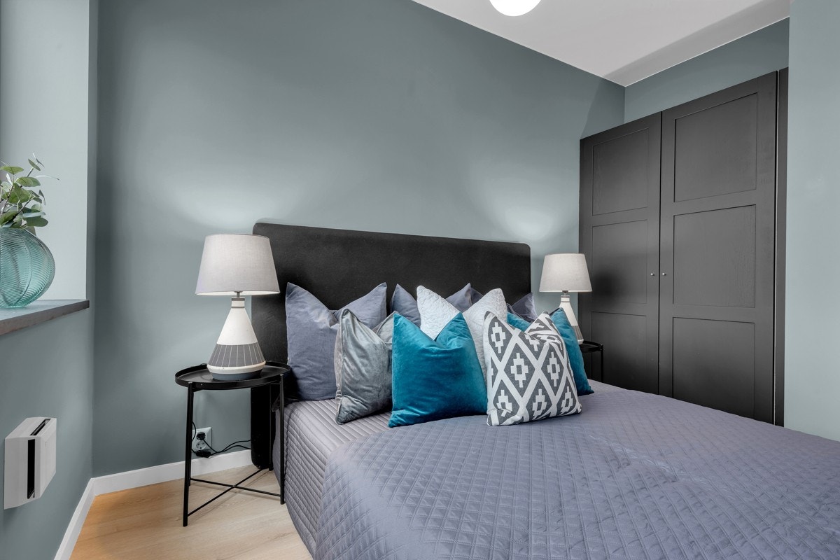 Lyst og romslig soverom med garderobeskap som medfølger. Galleribilde