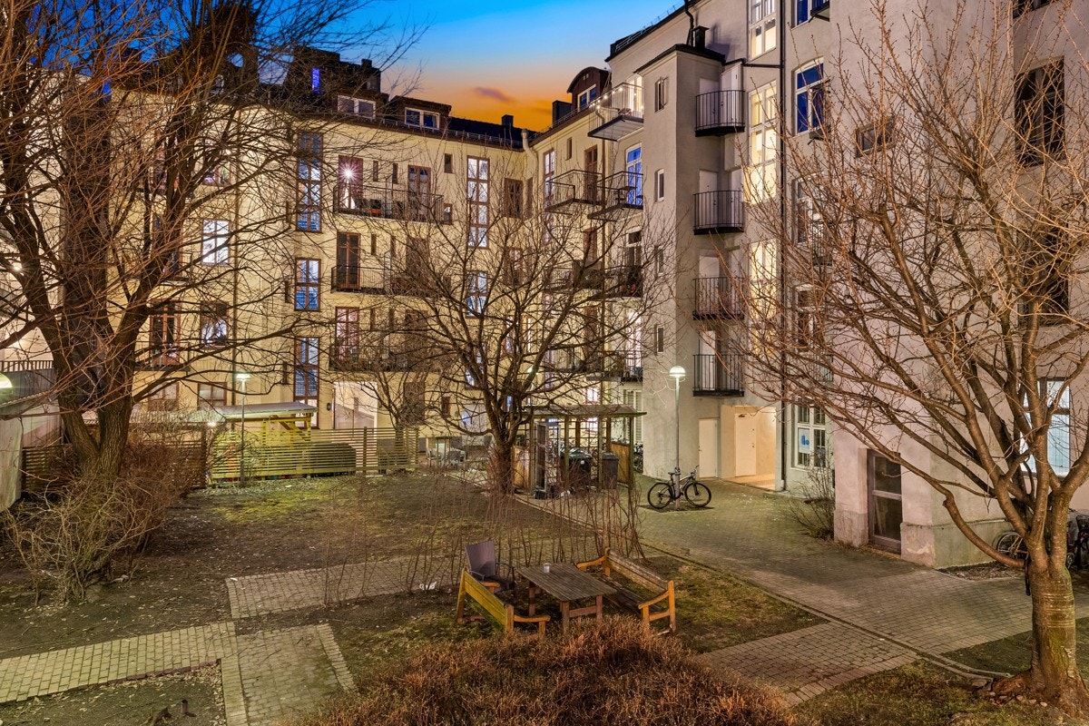 Utsikt fra balkongen mot pent opparbeidet og skjermet gårdsrom. Galleribilde