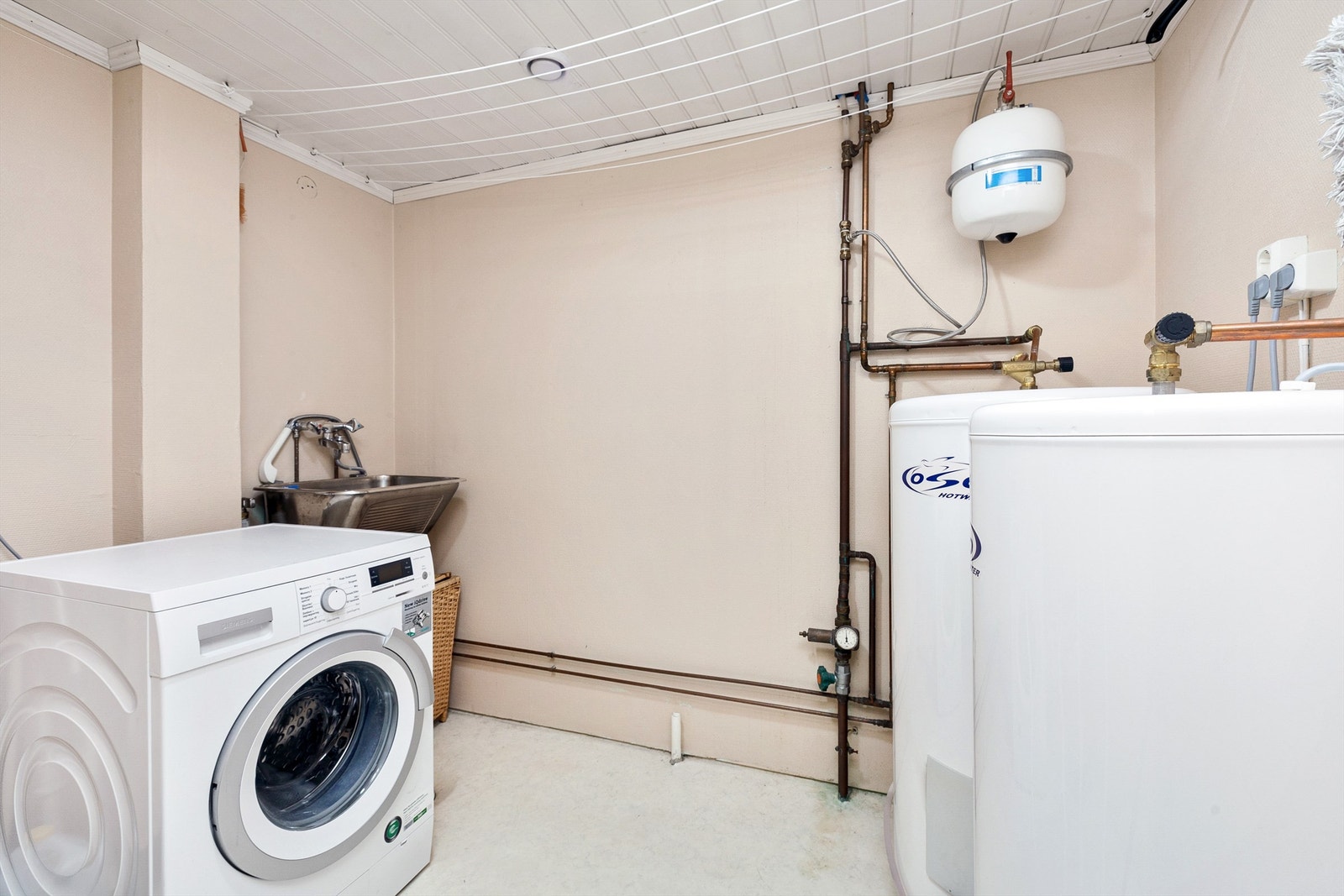 Praktisk vaskerom med 2 x varmtvannstanker. Utslagsvask og opplegg for vaskesøyle Galleribilde