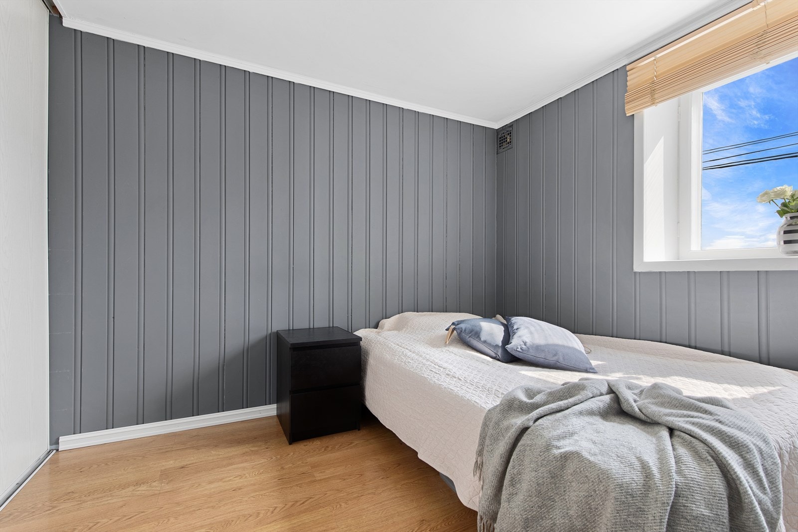 Soverom i hybelen med god plass for oppbevaring av tøy i skyvedørsgarderobe Galleribilde