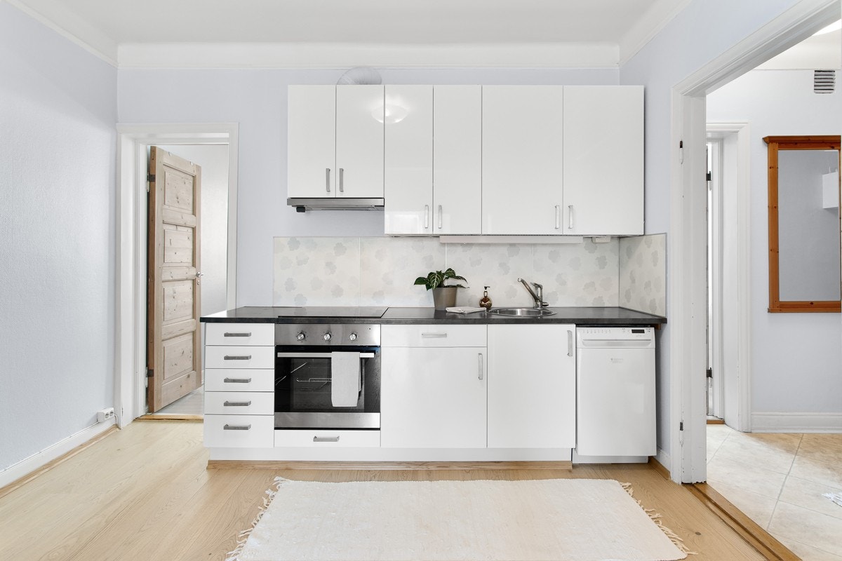 Innredningen fra 2013 er hvit, og har slette fronter i høyglans og mørk laminat benkeplate med nedfelt stålkum. Galleribilde