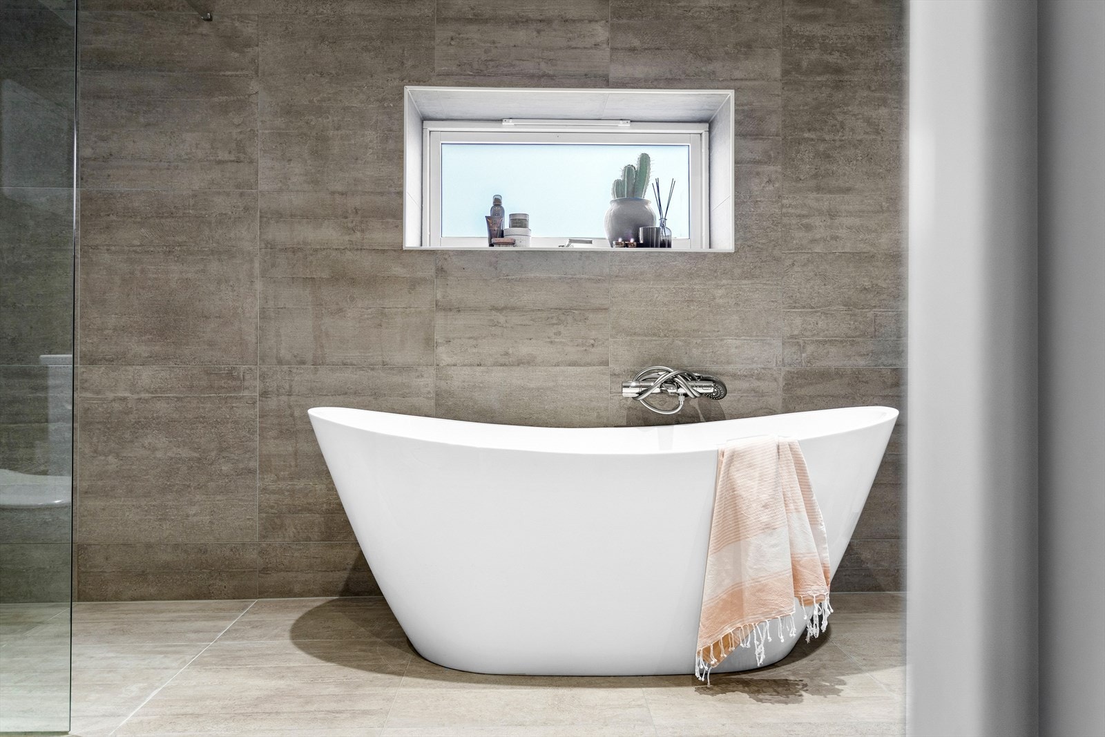 Innbydende baderom med badekar og dusjsone med regnfallsdusj Galleribilde