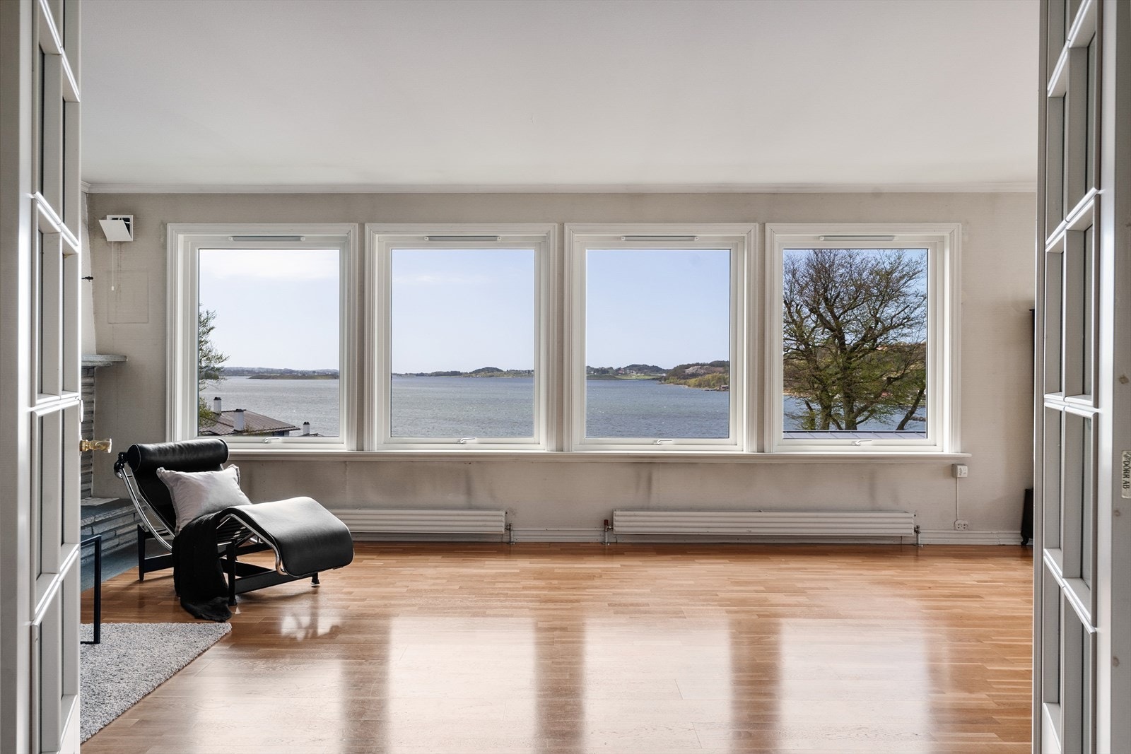 Lys og romlig stue og spisestue med parkett på gulv Galleribilde