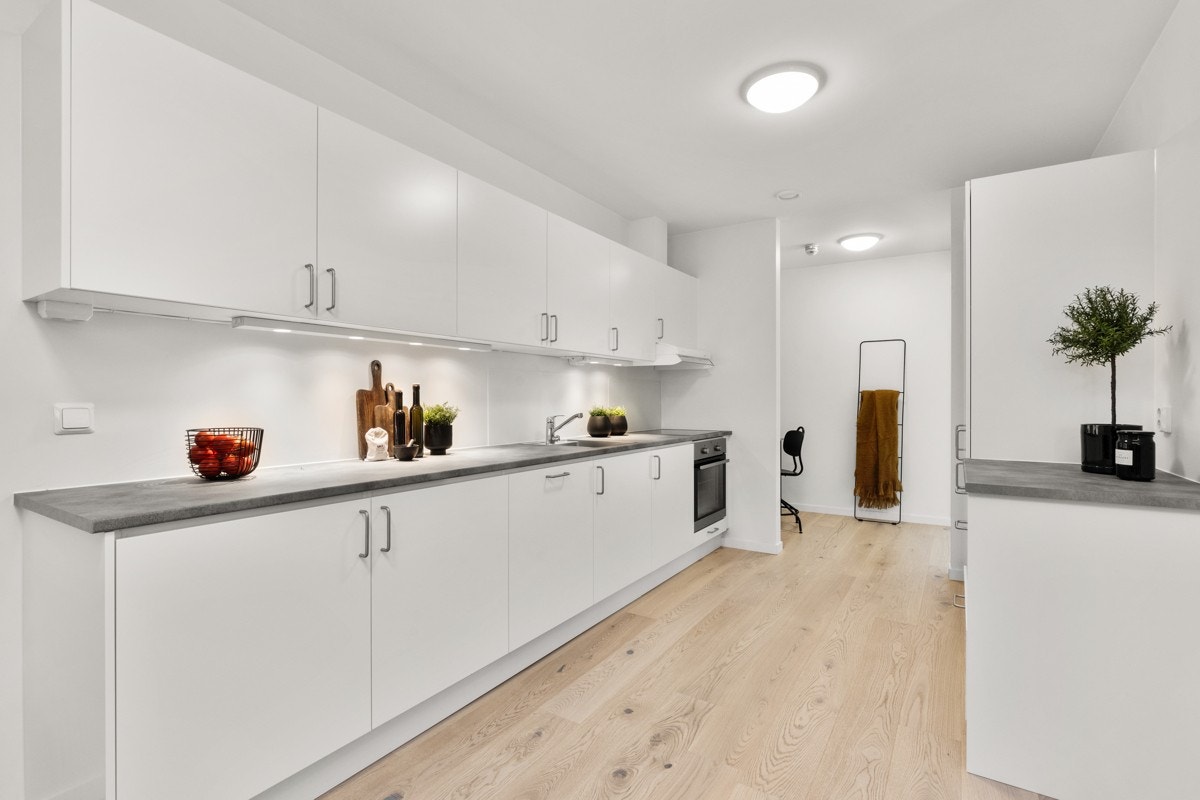 Kjøkkenet er av slette hvite overflater med god plass til spisestue. Galleribilde