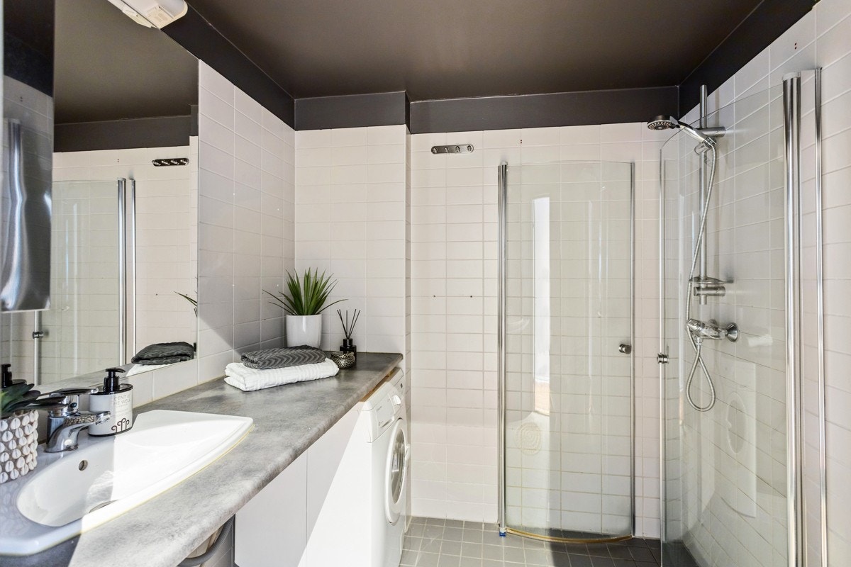 Delikat og flislagt baderom fra 2006. Baderommet inneholder dusjnisje, toalett, samt porselensservant nedfelt i benkeplaten. Galleribilde