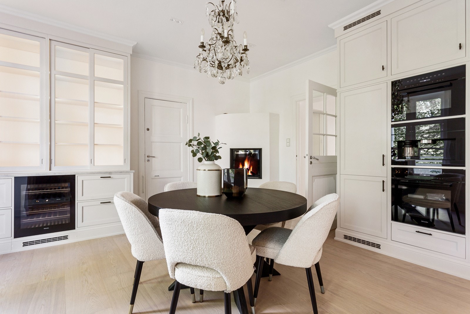 Kjøkkeninnredningen har lyse rammefronter, vitrineskap med belysning og belysning under overskapene. Galleribilde