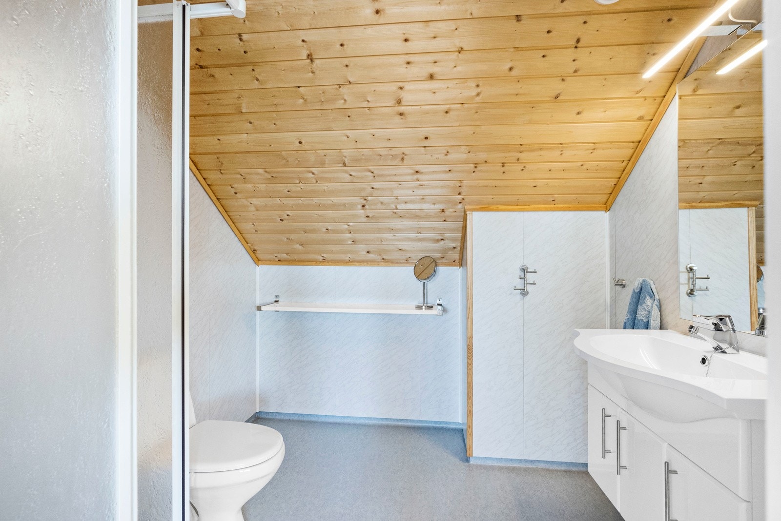 Bad på loft med standard fra byggeår - Innredet med dusjkabinett, klosett og baderomsinnredning Galleribilde