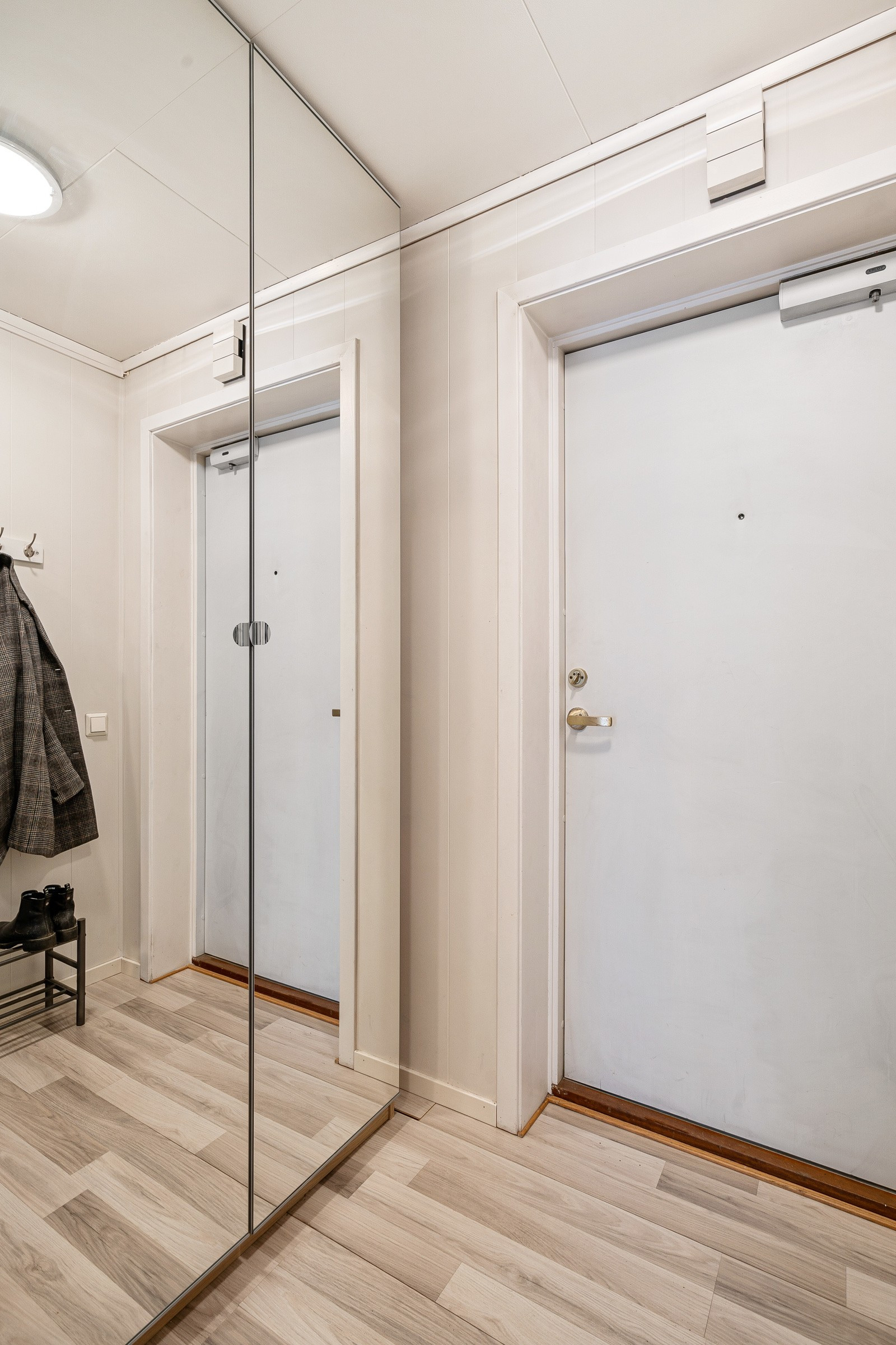 Velkommen inn. Entréen gir et godt førsteinntrykk av boligen med stor skyvedørsgarderobe og lyse overflater.