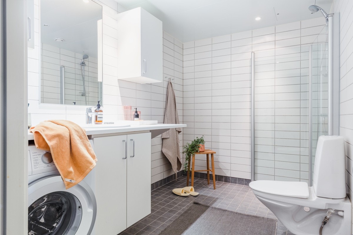 Et stort og pent flislagt bad ligger praktisk til ved entrèen. Galleribilde