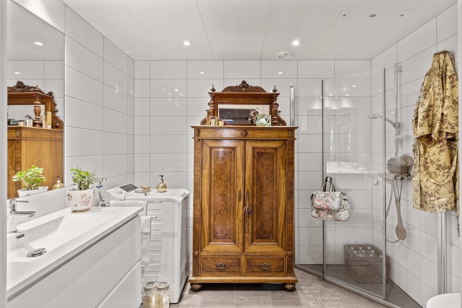 Badet er utstyrt med servant med underskap, dusjnisje, opplegg til vaskemaskin og toalett. Galleribilde