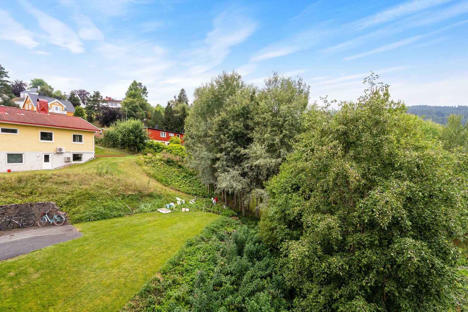 Fra stuen og den franske balkongen kan du nyte en utmerket utsikt over frodige grøntarealer Galleribilde