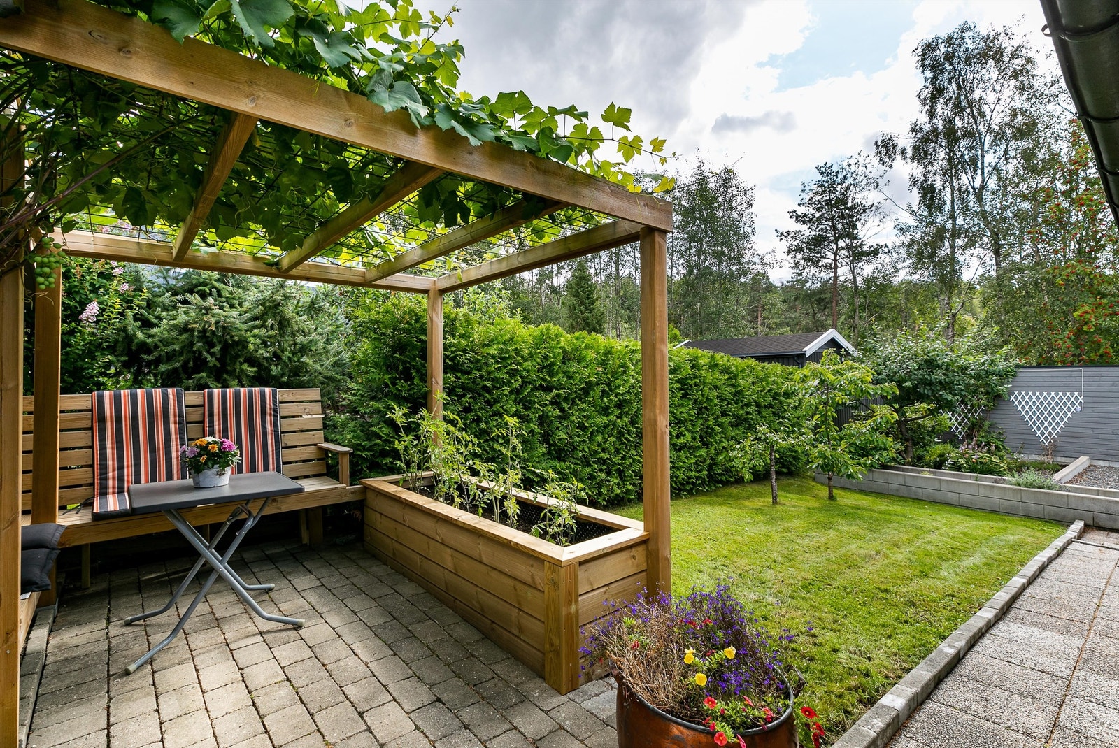 Bakhagens moderne pergola er et ypperlig sted å ta med helgefrokostene til sommerstid. Galleribilde