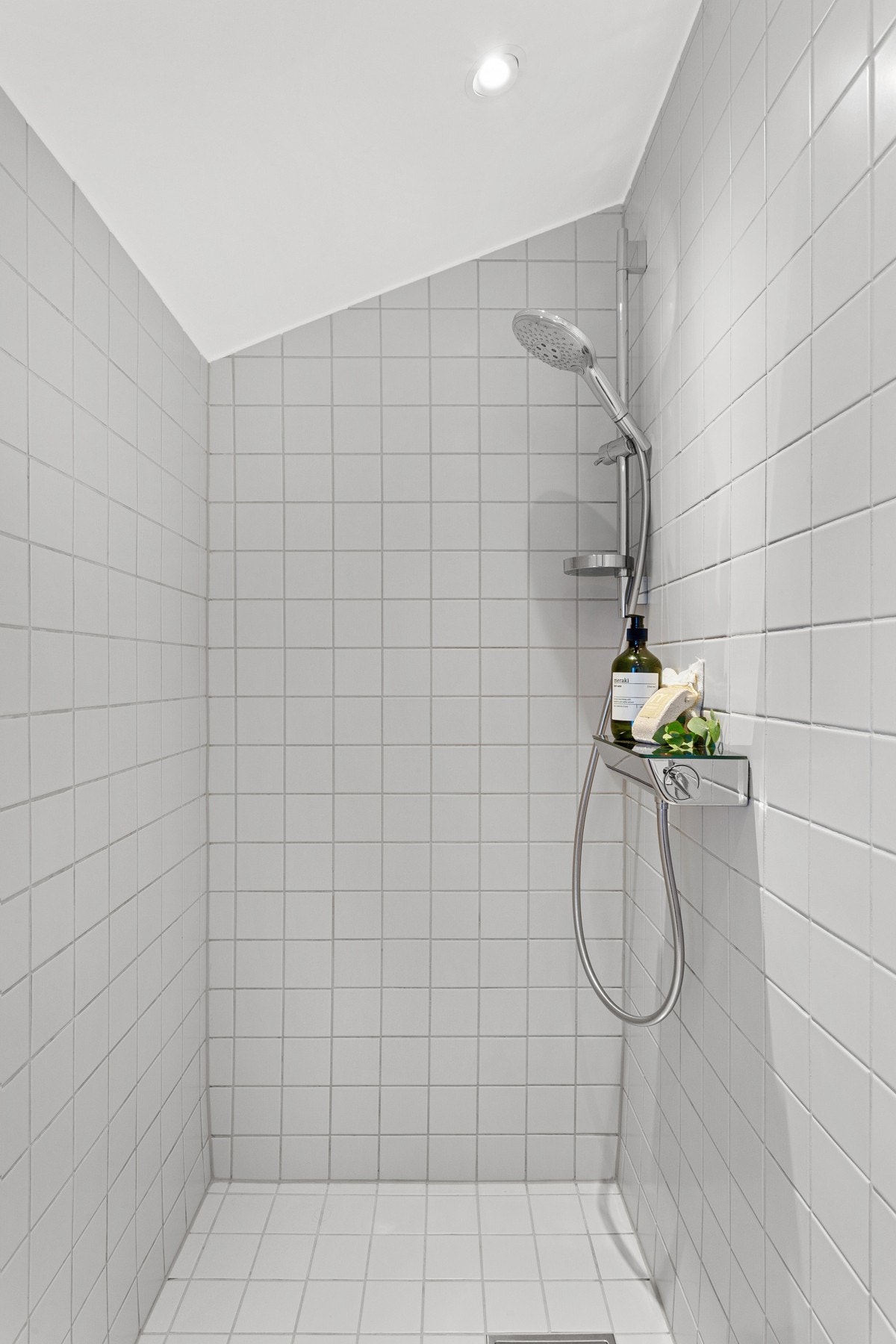 Badet har påkostede servant- og dusjarmaturer fra HANSGROHE. Lysegrå fliser i dusjsone. Galleribilde