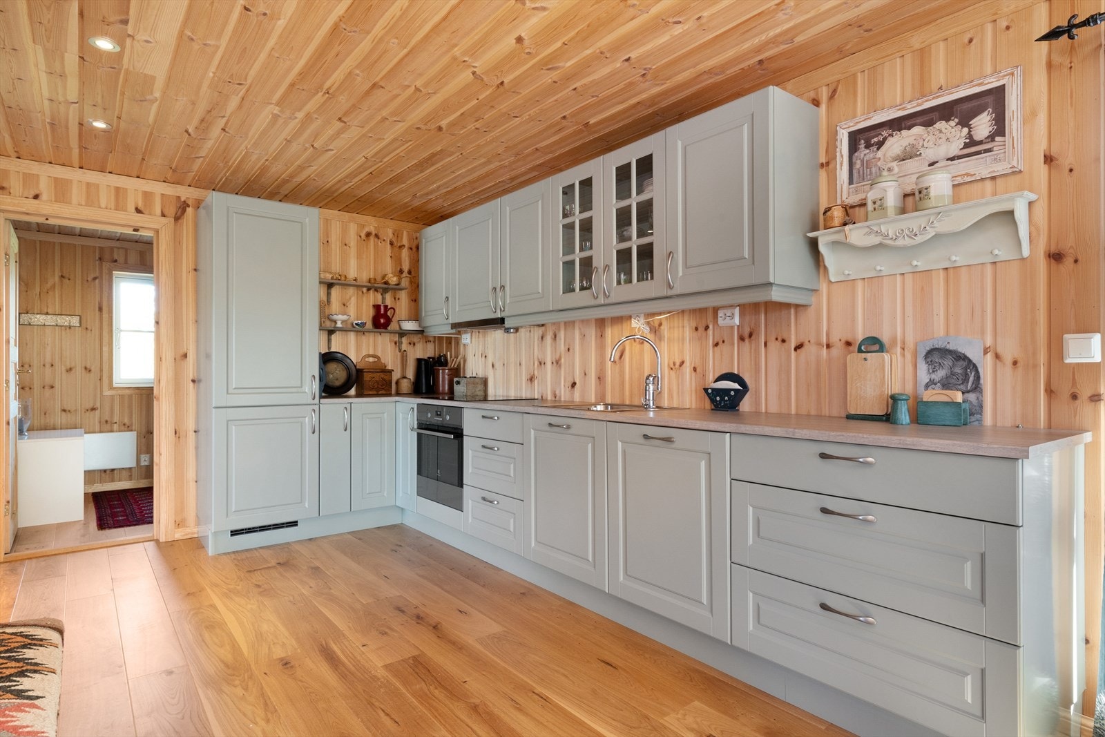 Pent kjøkken i gråtone med integrerte hvitevarer. Galleribilde