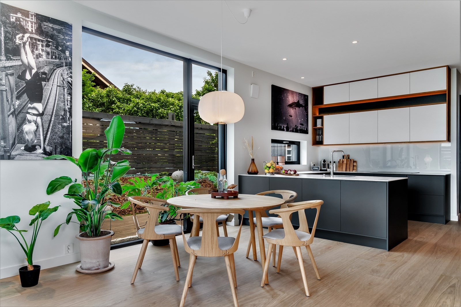 Designkjøkken med kompakt benkeplate med ekstra dybde mot stuen. Galleribilde