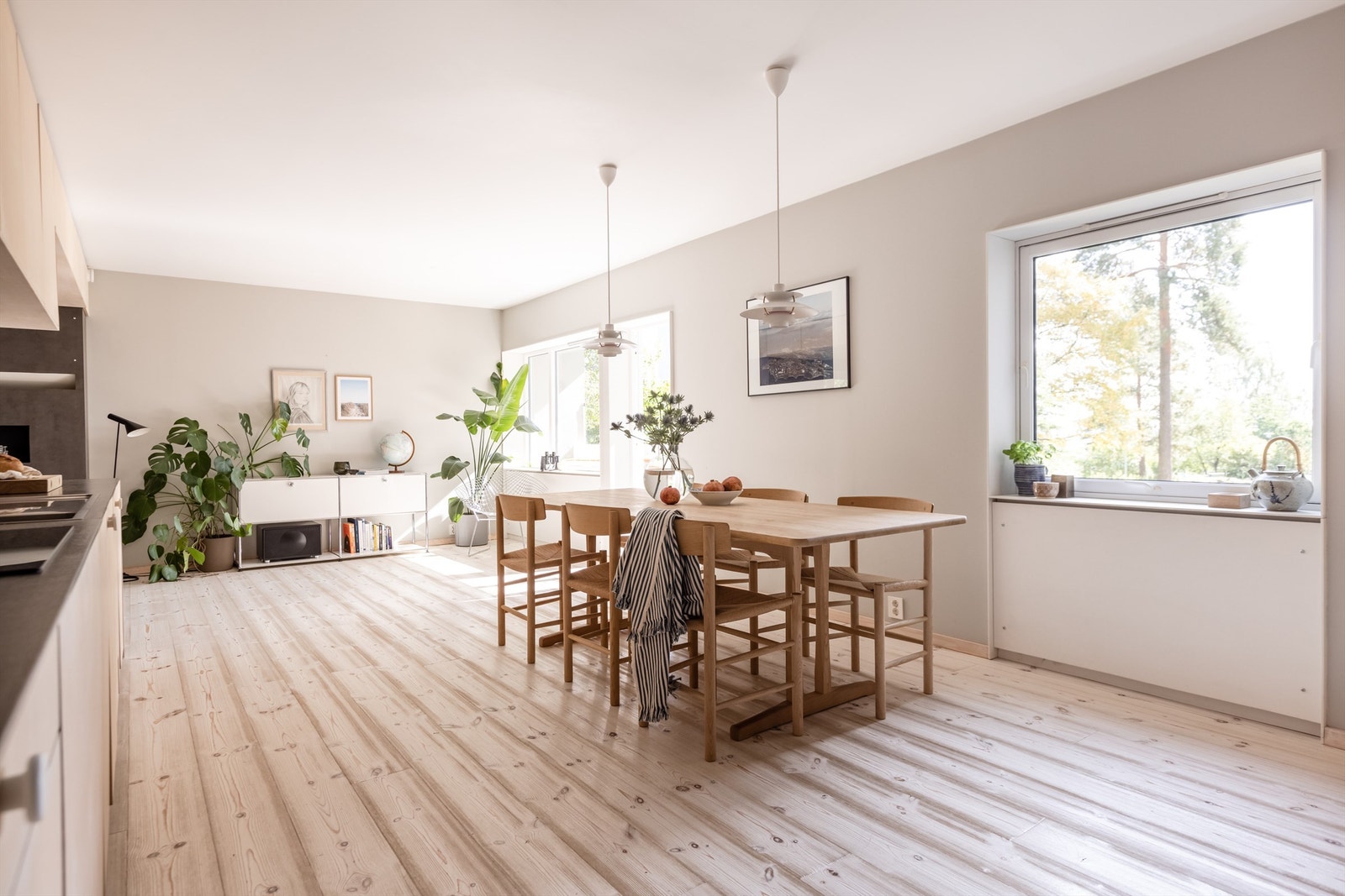 Et svært innbydende og sosialt oppholdsrom hvor stuedelen er delvis åpen mot kjøkken, med en varm og behagelig gasspeis i sentrum. Galleribilde