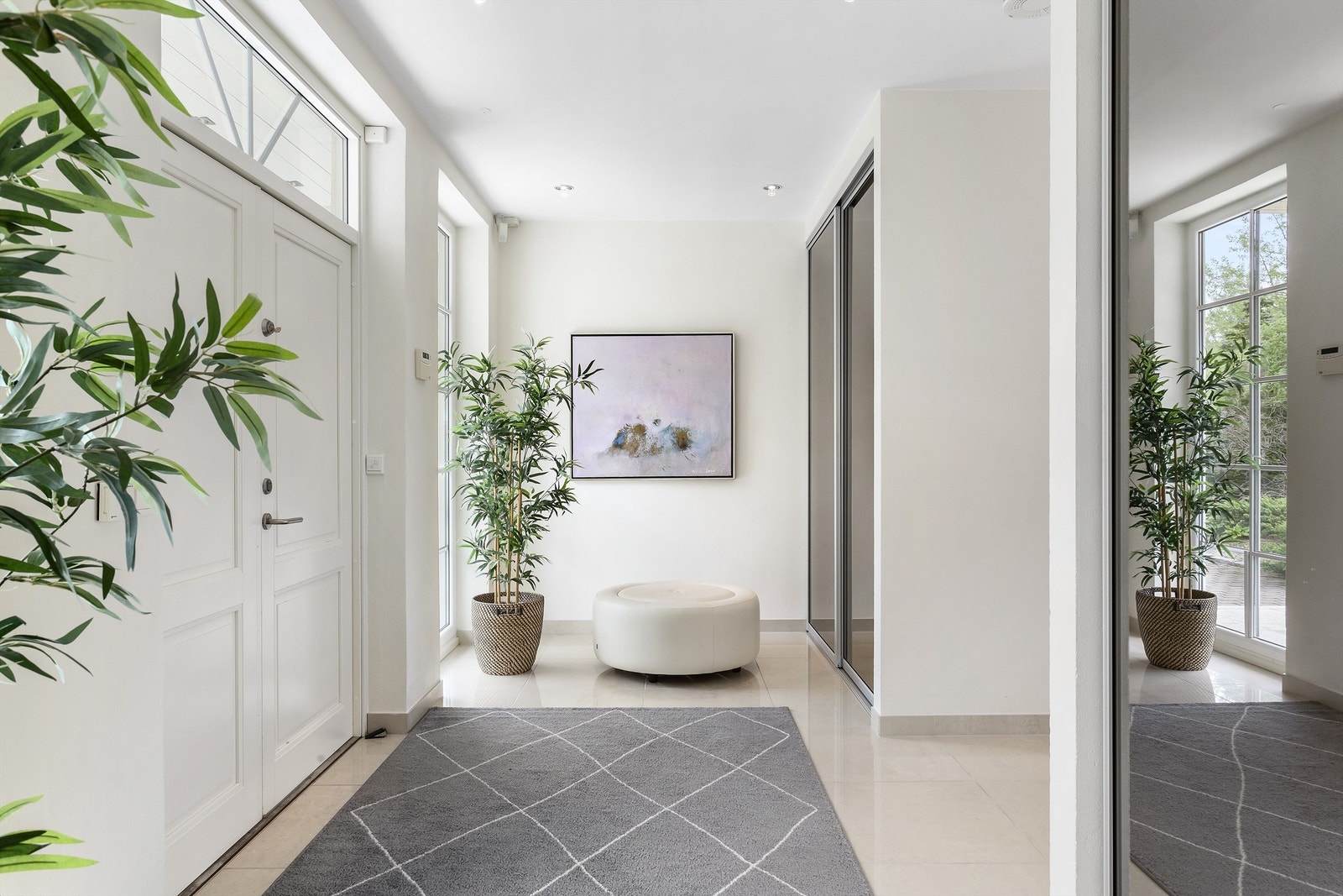 Velkommen inn! En smart hall med plassbygde skyvedørsgarderober leder videre mot hall og hovedstue. Galleribilde