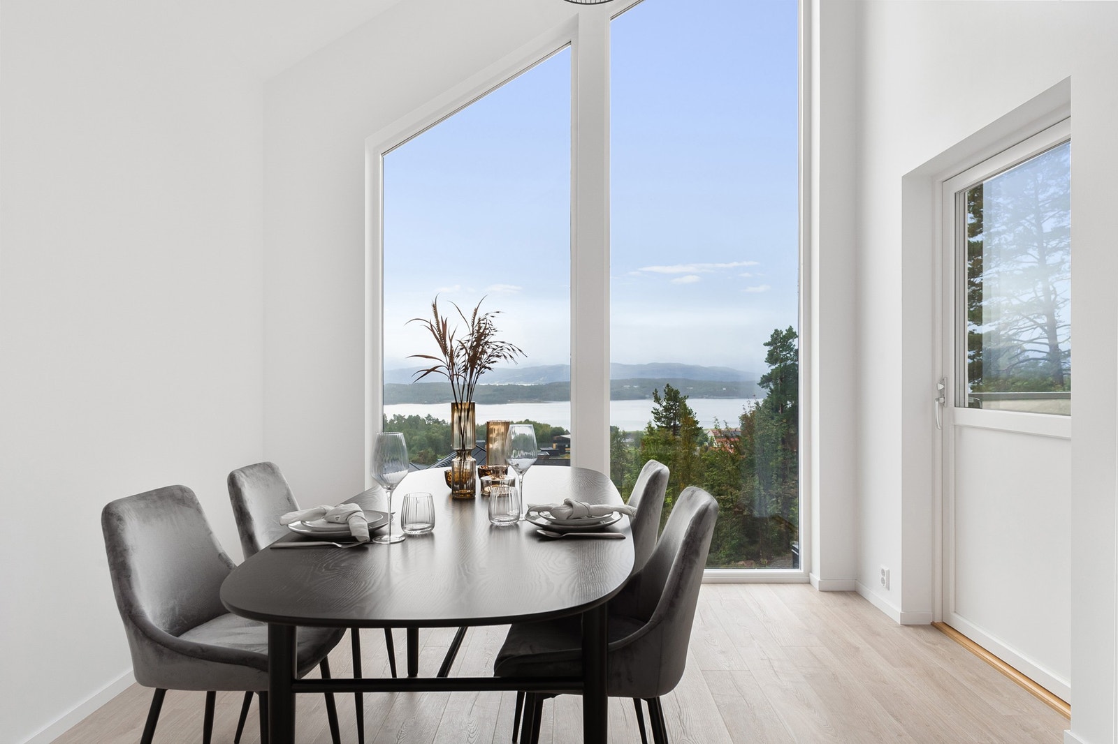 Åpen himling og vindu fra gulv til tak skaper god romfølelse Galleribilde