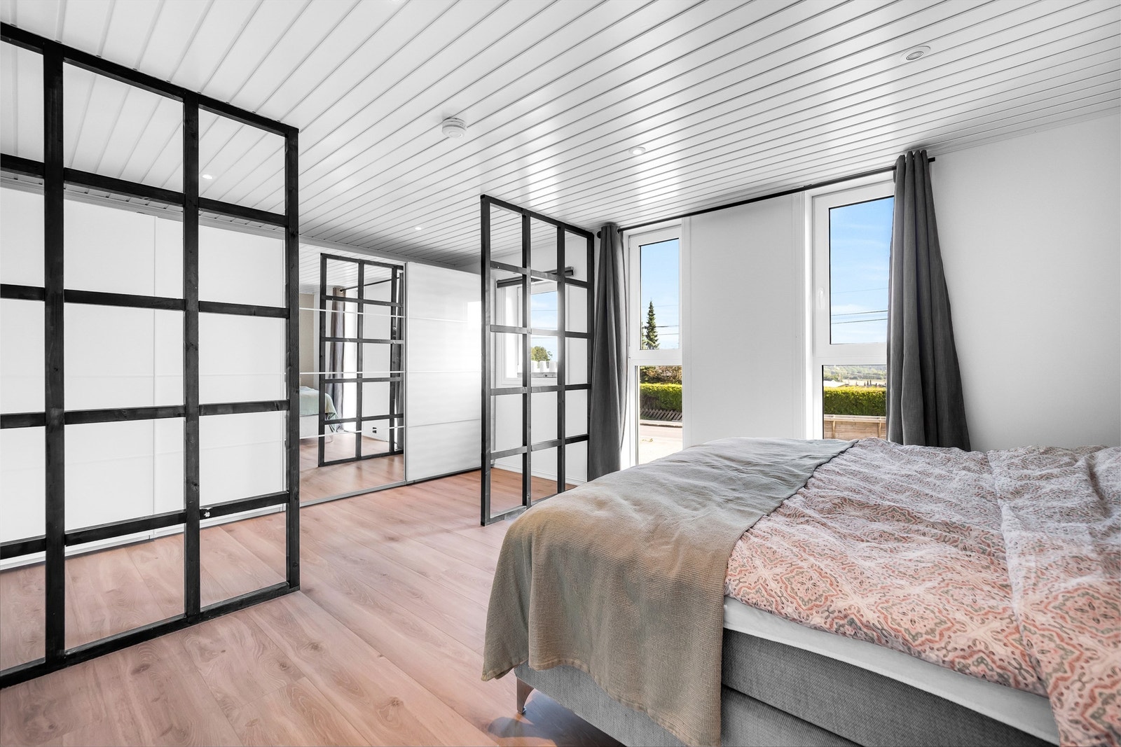 Hovedsoverommets garderobe er adskilt ved hjelp av tidsaktuelle romdelere og utstyrt med en omfangsrik skyvedørsgarderobe. Galleribilde