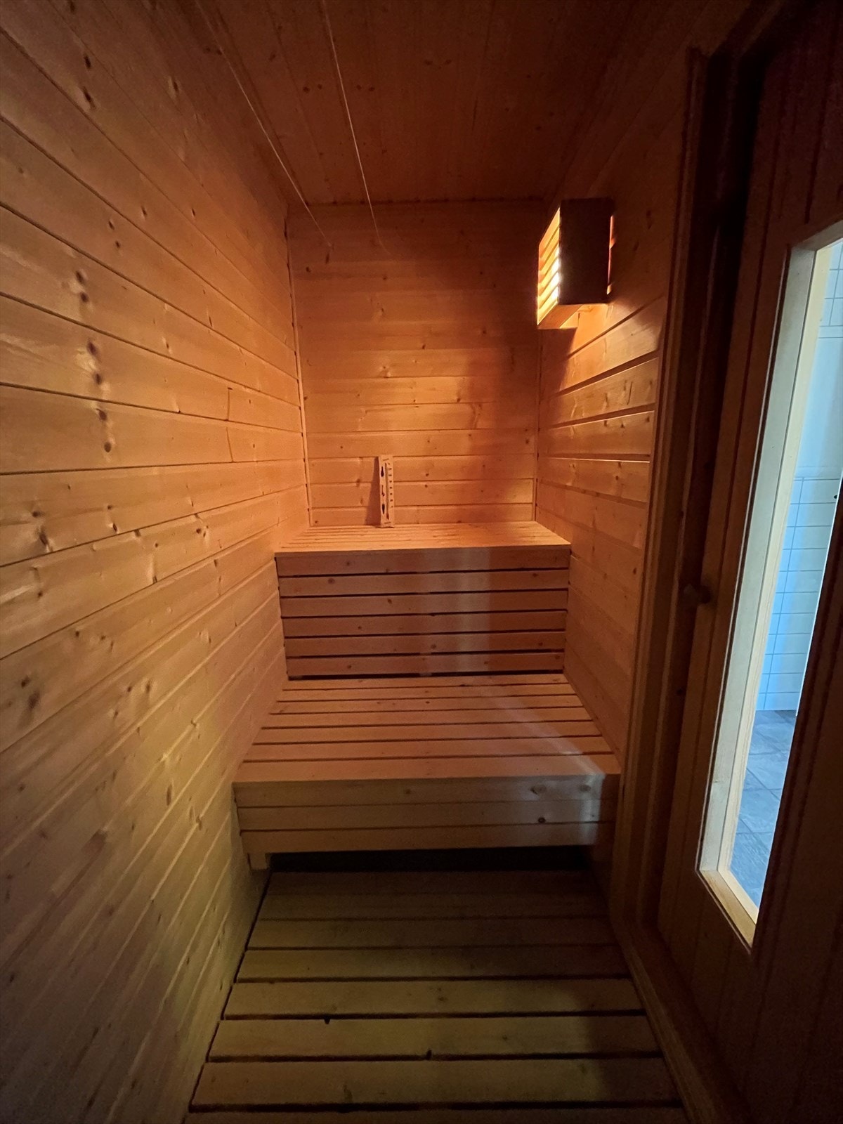 Badstue med trebenker og elektrisk badstueovn. Galleribilde