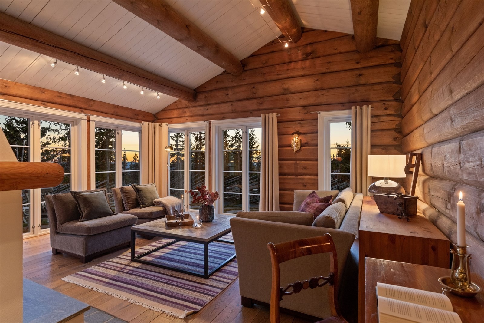 Hytten holder det lune hyttepreget med massive tømmervegger og god takhøyde. Galleribilde