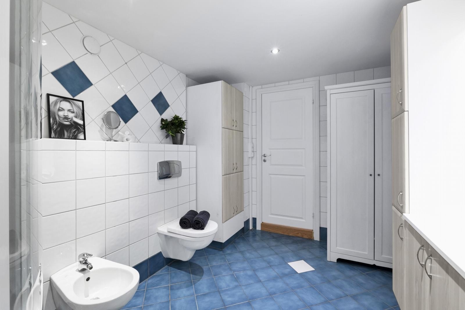 Badet er utstyrt med en servantinnredning, vegghengt toalett og lukket dusjkabinett. Galleribilde