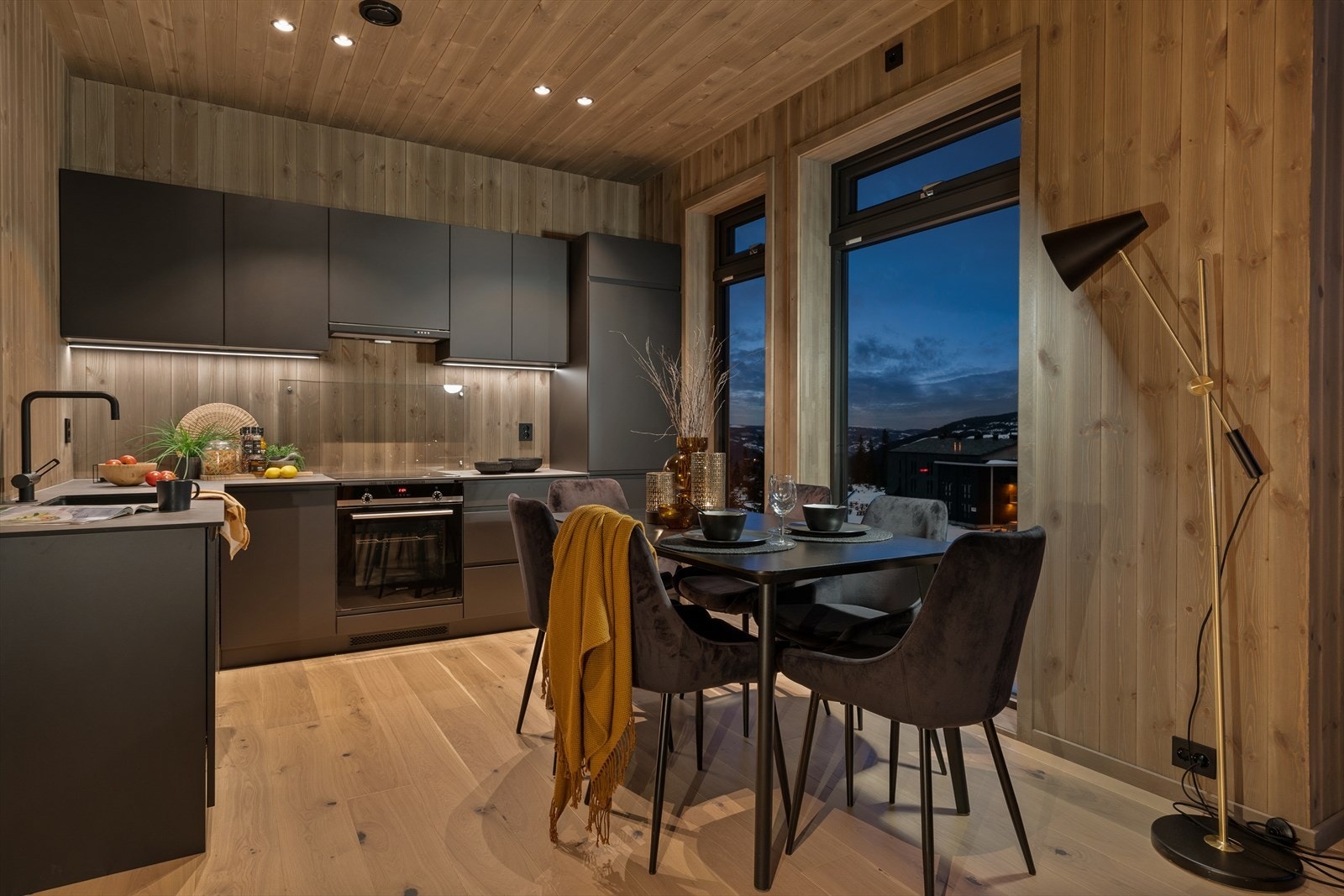 Kjøkkeninnredning med matte gråmalte overflater og svarte detaljer Galleribilde