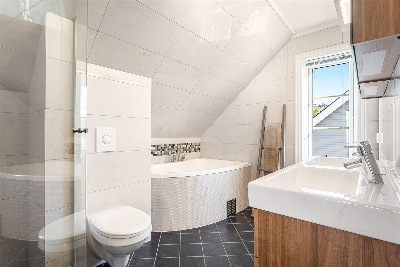 Stort og delikat baderom i boligens 2.etasje. Her er det både dusjnisje med glassvegger, dbl. servant samt hjørnebadekar Galleribilde