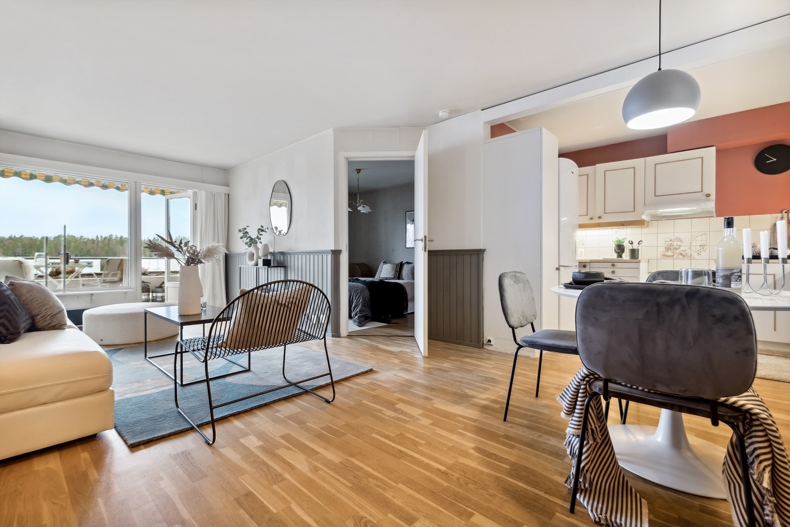 Boligens stue er åpen og er preget av store vindusflater som gir rikelig med lys til rommet Galleribilde