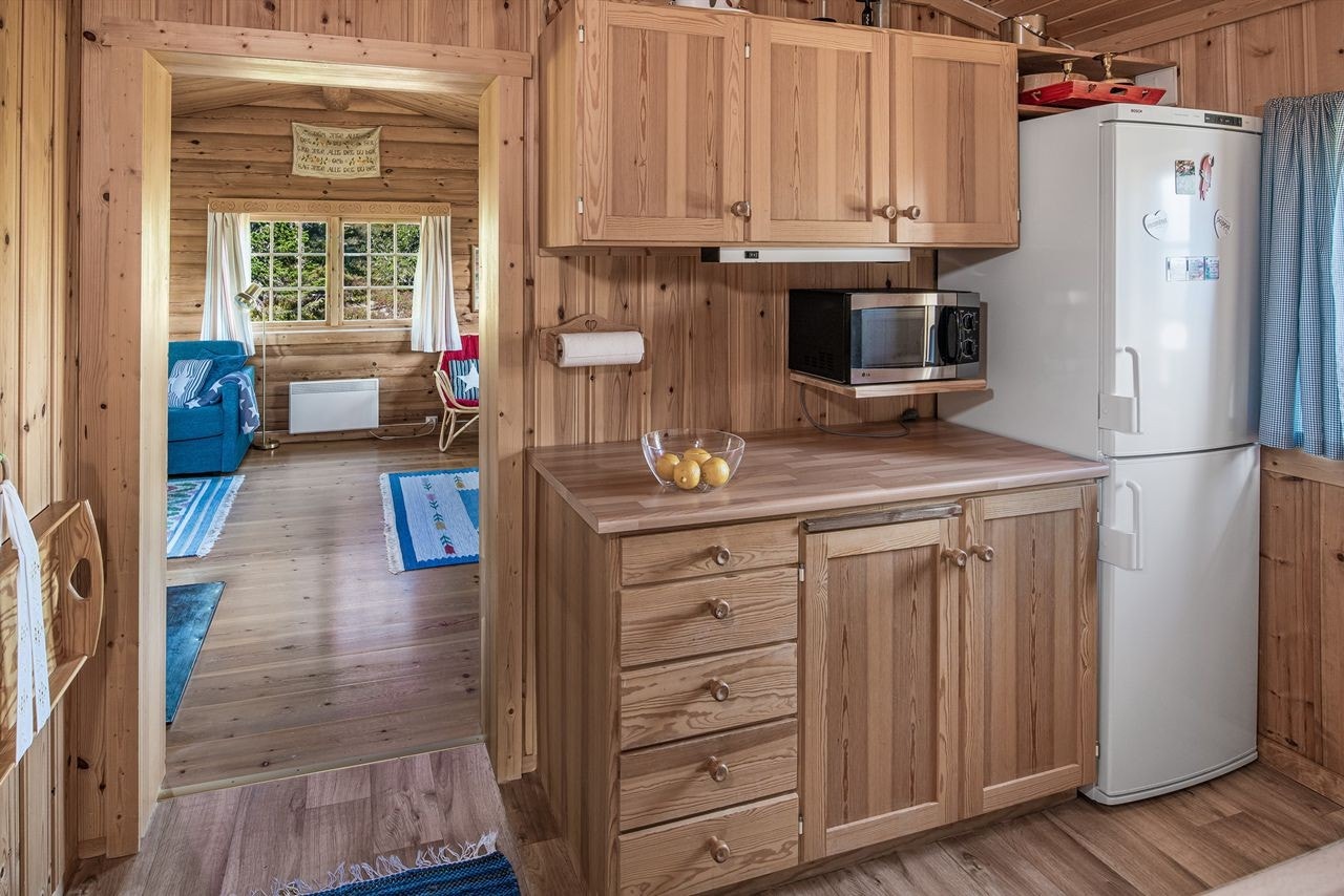 Kjøkkenkroken ligger rett innenfor stua. Åpen løsning for hvitevarer som medfølger i salget Galleribilde